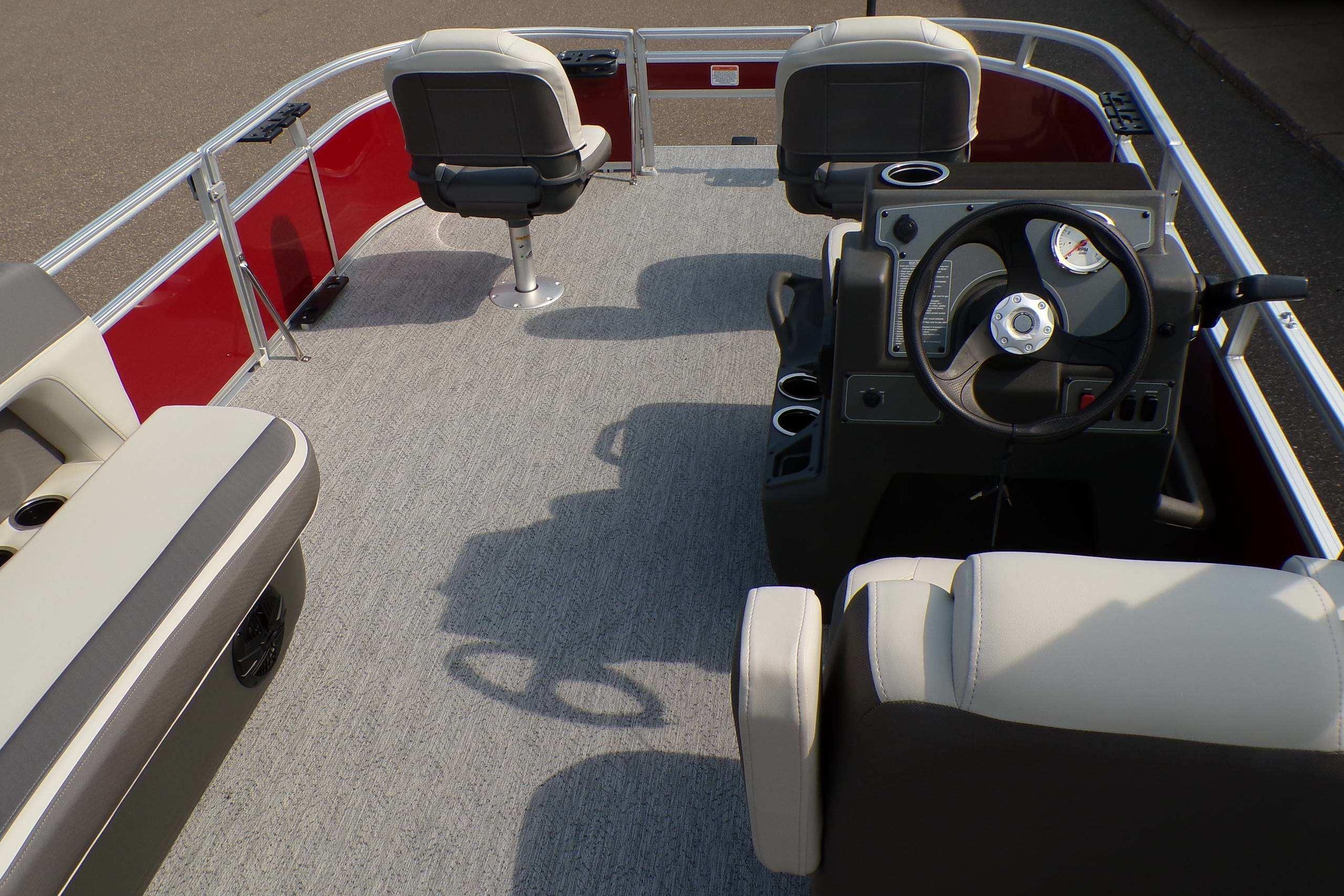 2026 Sun Tracker Bass Buggy 16 XL Select pontoon boat interior with steering console and seating.