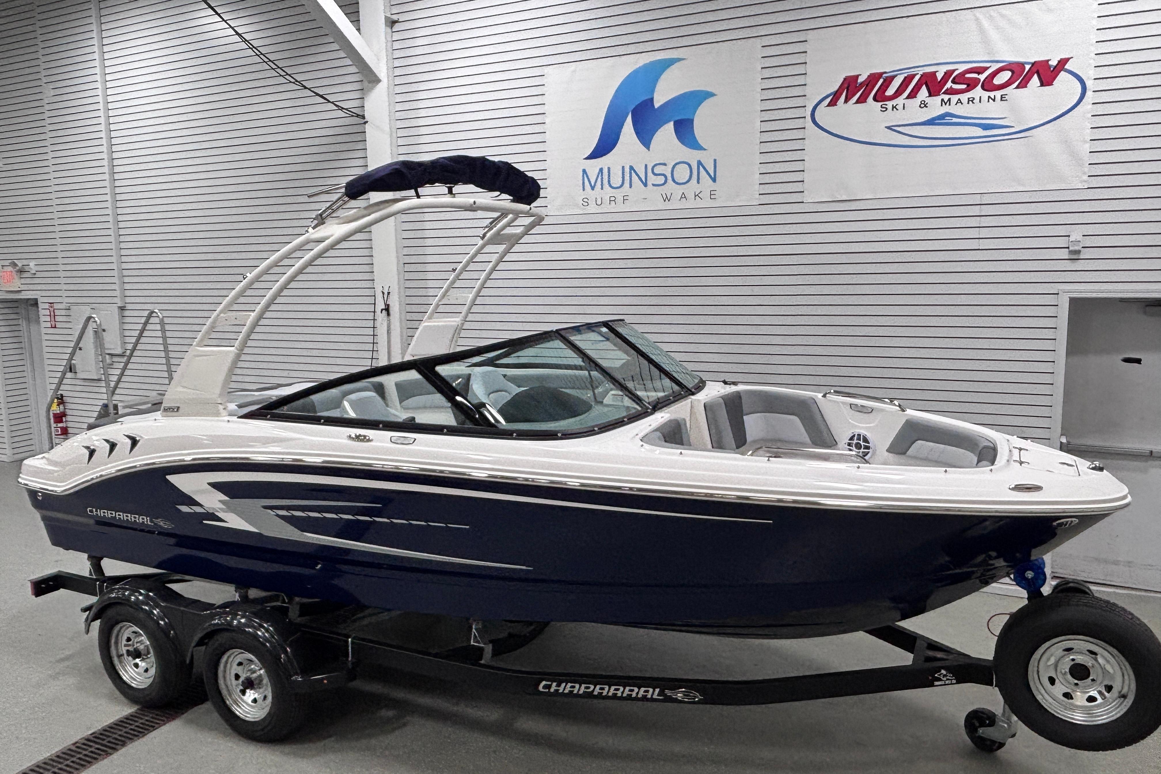 2026 Chaparral 21 SSi boat on trailer at Munson Ski & Marine showroom.