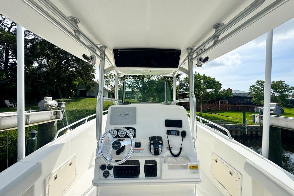 2018 Mako 284 Center Console boat interior with steering wheel and controls.