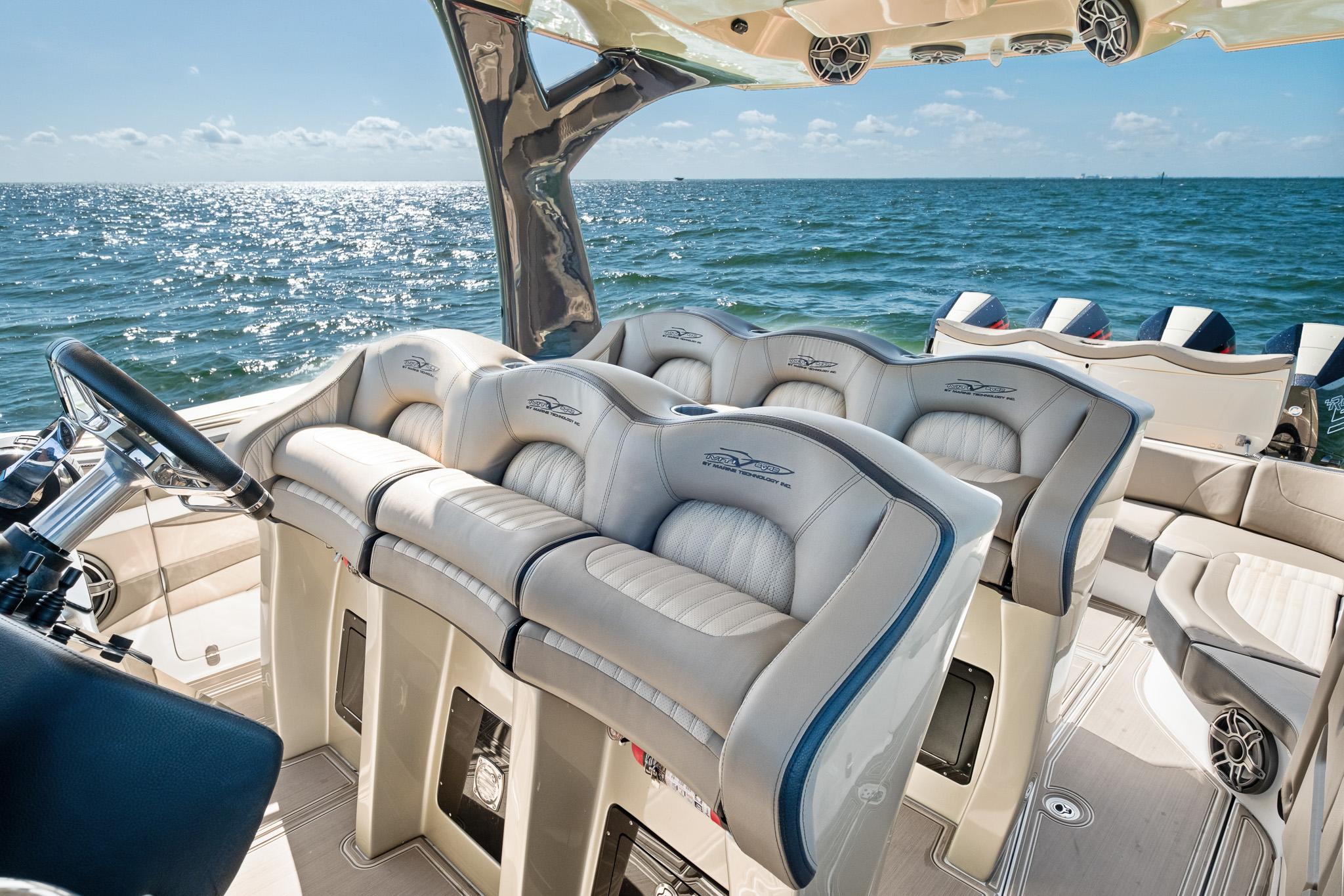 Luxurious MTI V42 boat interior with plush seating, overlooking the ocean, 2021 model.