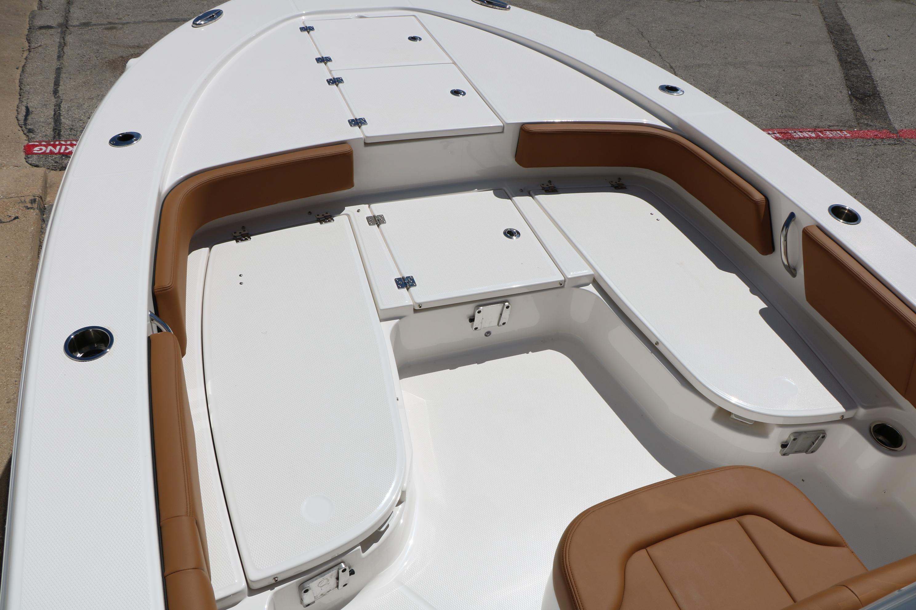 2026 Robalo 246 Cayman boat interior with cushioned seating and storage compartments.