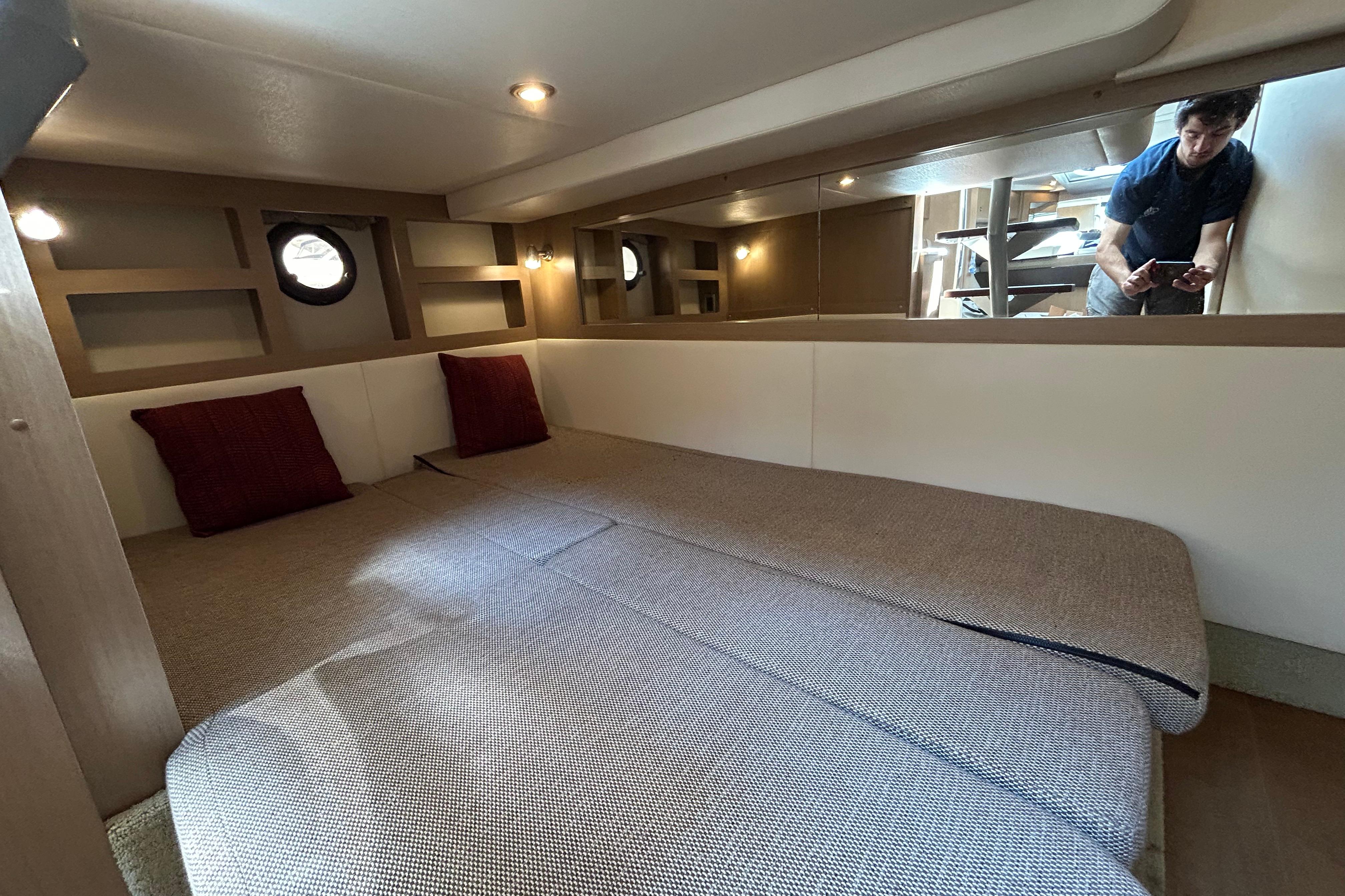 Interior cabin of 2019 Sea Ray Sundancer 350 with cozy bedding and modern design.