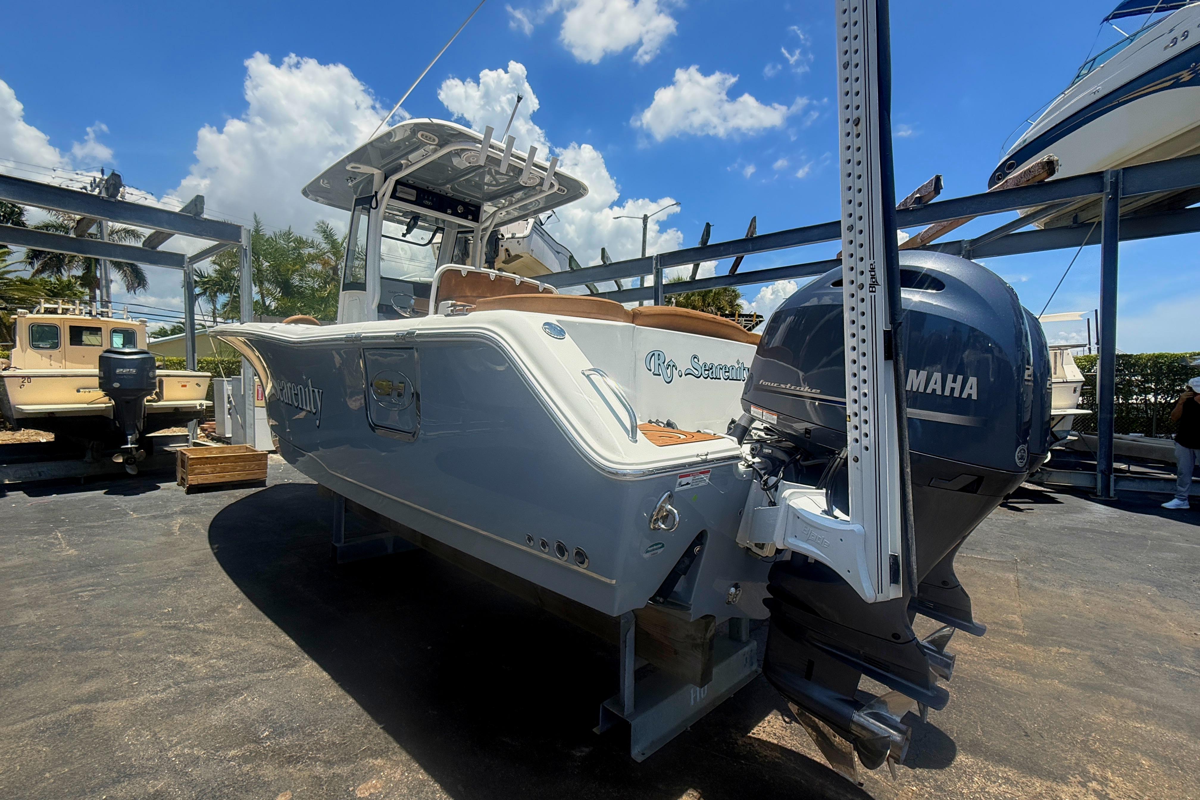 2020 Sea Hunt Ultra 275 SE boat with Yamaha engine, docked under a sunny sky.