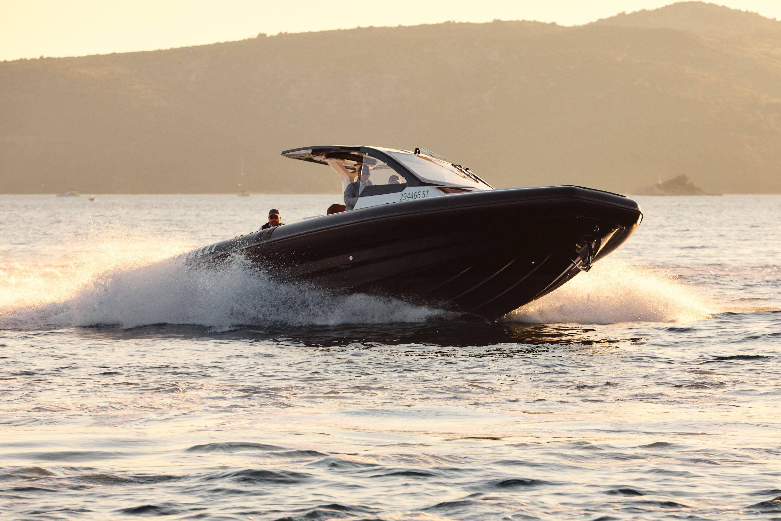 2025 Pirelli 35 boat cruising on water at sunset, showcasing sleek design and performance.