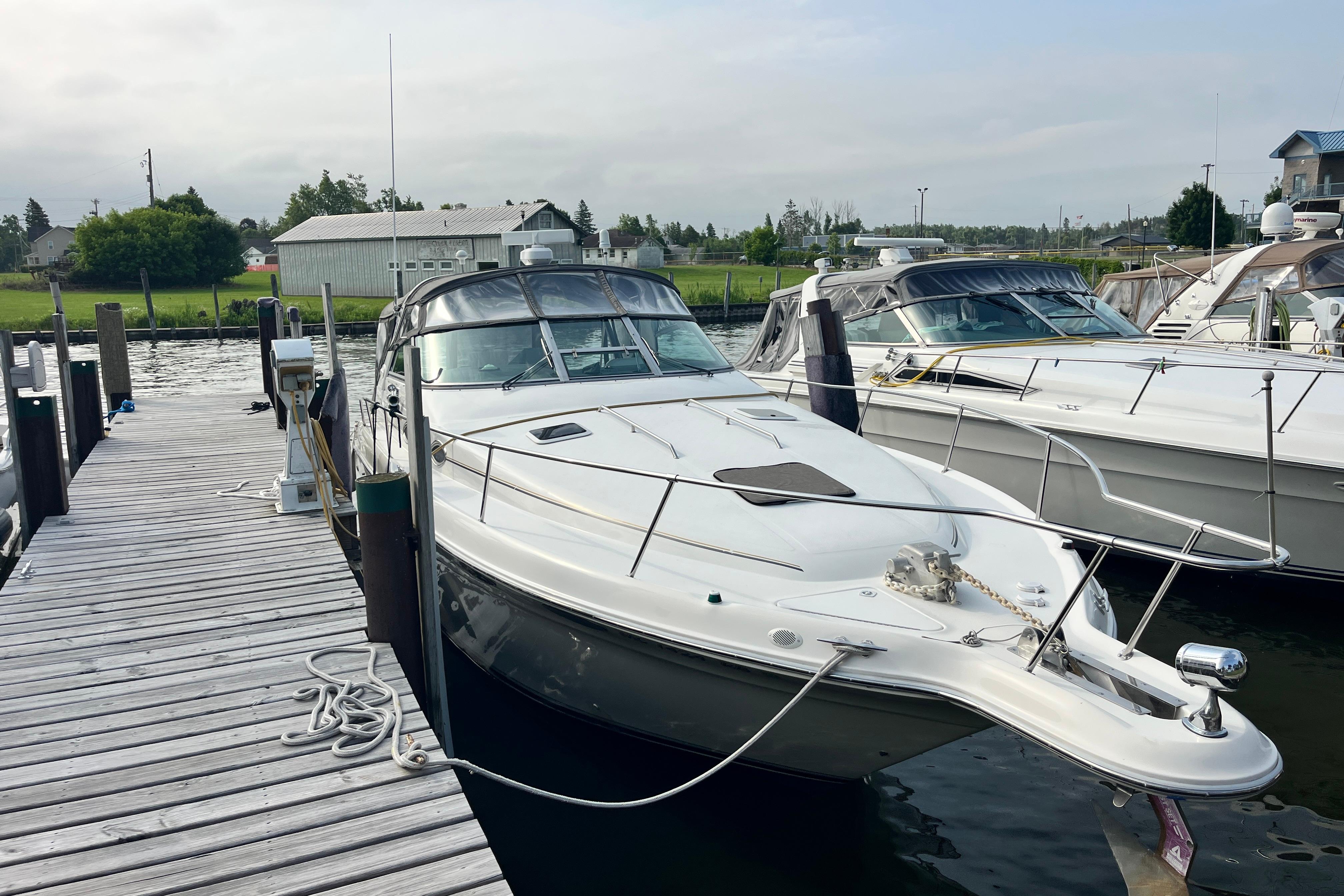 1995 Sea Ray Sundancer 330 docked at a marina, showcasing sleek design and spacious deck.