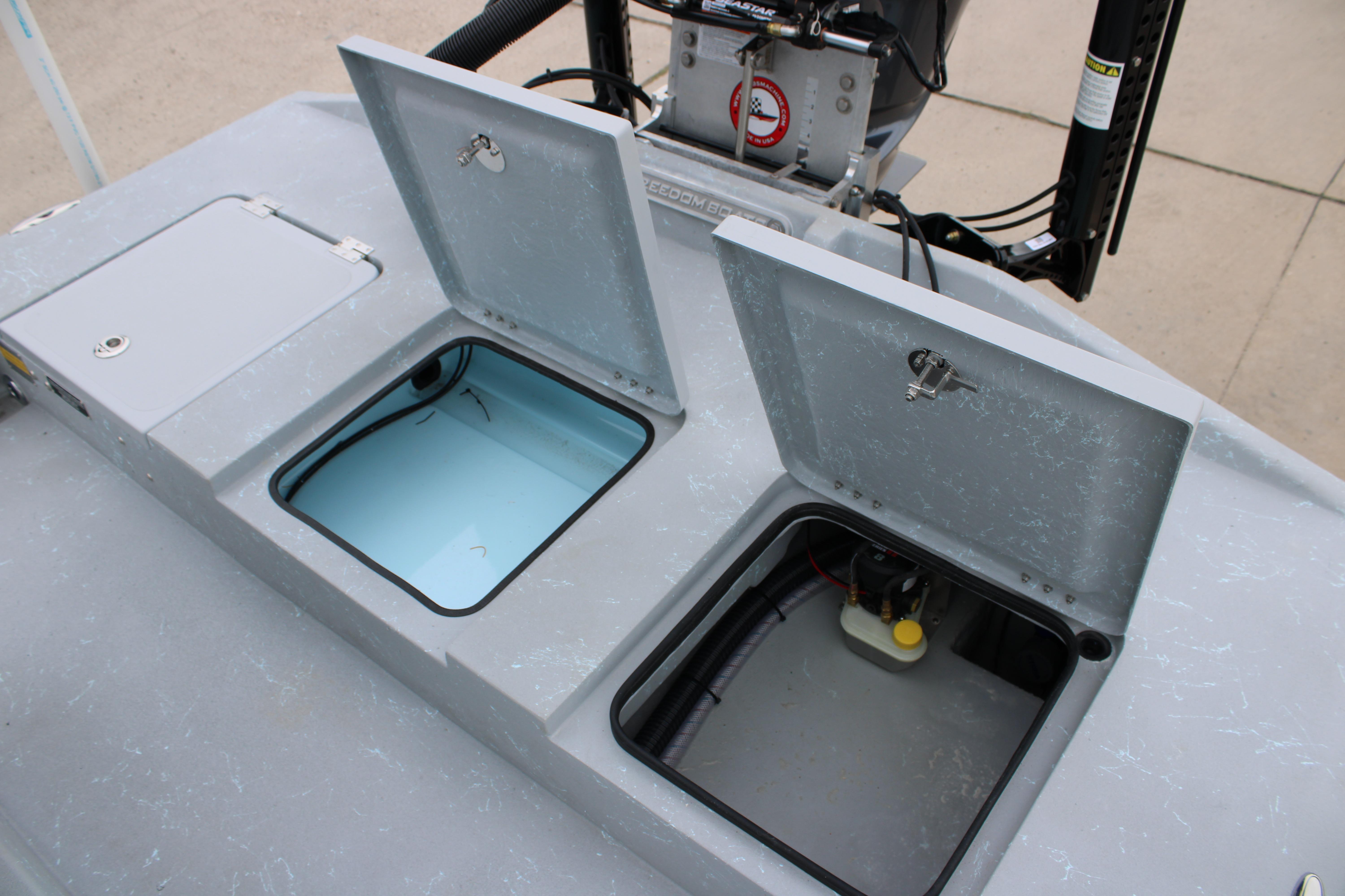 Open storage compartments on a 2026 Freedom Boats 24 Defender.