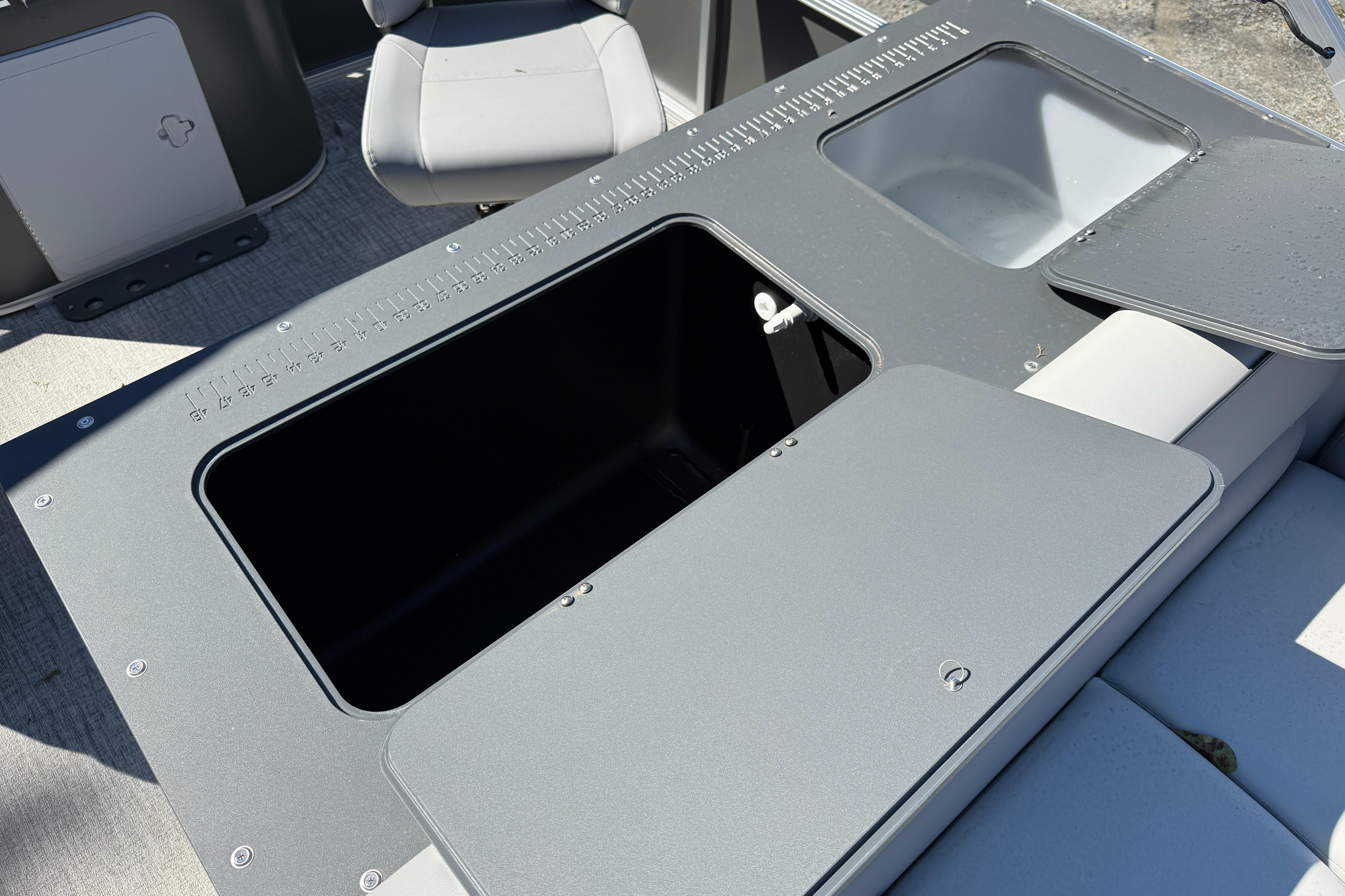 2026 Tahoe Pontoon Sport 85 Rear Fish boat interior with storage compartments and seating.