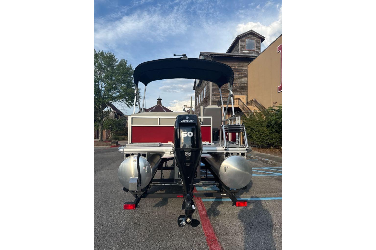 2026 Sun Tracker Bass Buggy 16 XL Select pontoon boat with Mercury outboard motor.