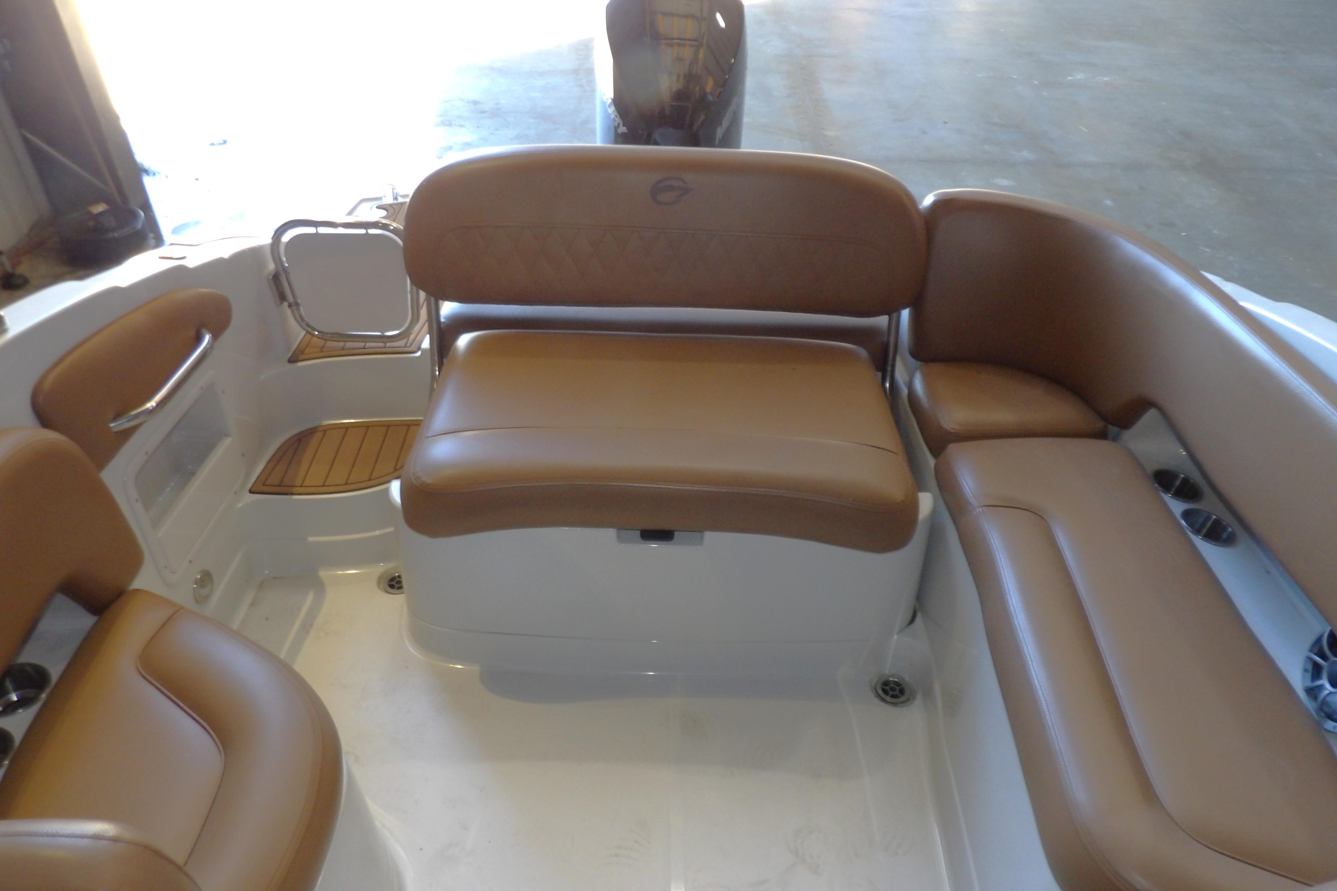 2023 Crownline 250 XSS boat interior with tan leather seating and white deck.