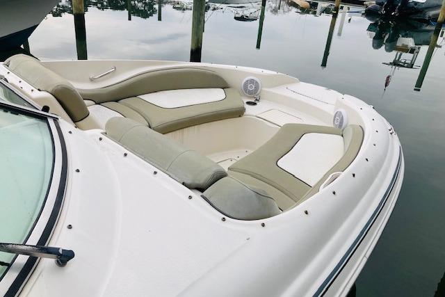 2006 Sea Ray 270 Sundeck boat with spacious seating, docked on calm water.