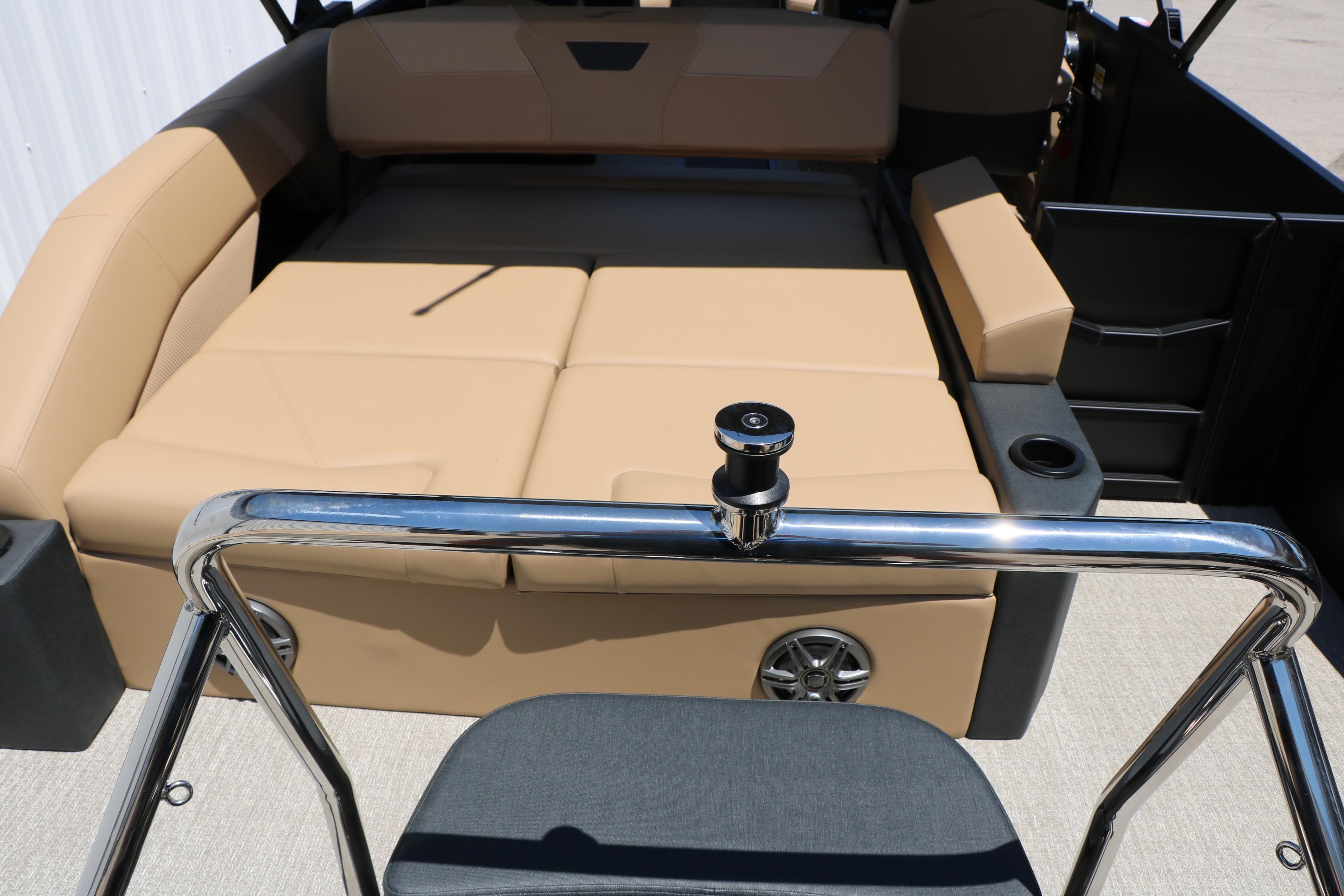 Luxurious interior of 2026 Evotti 521CS boat with beige seating and chrome accents.