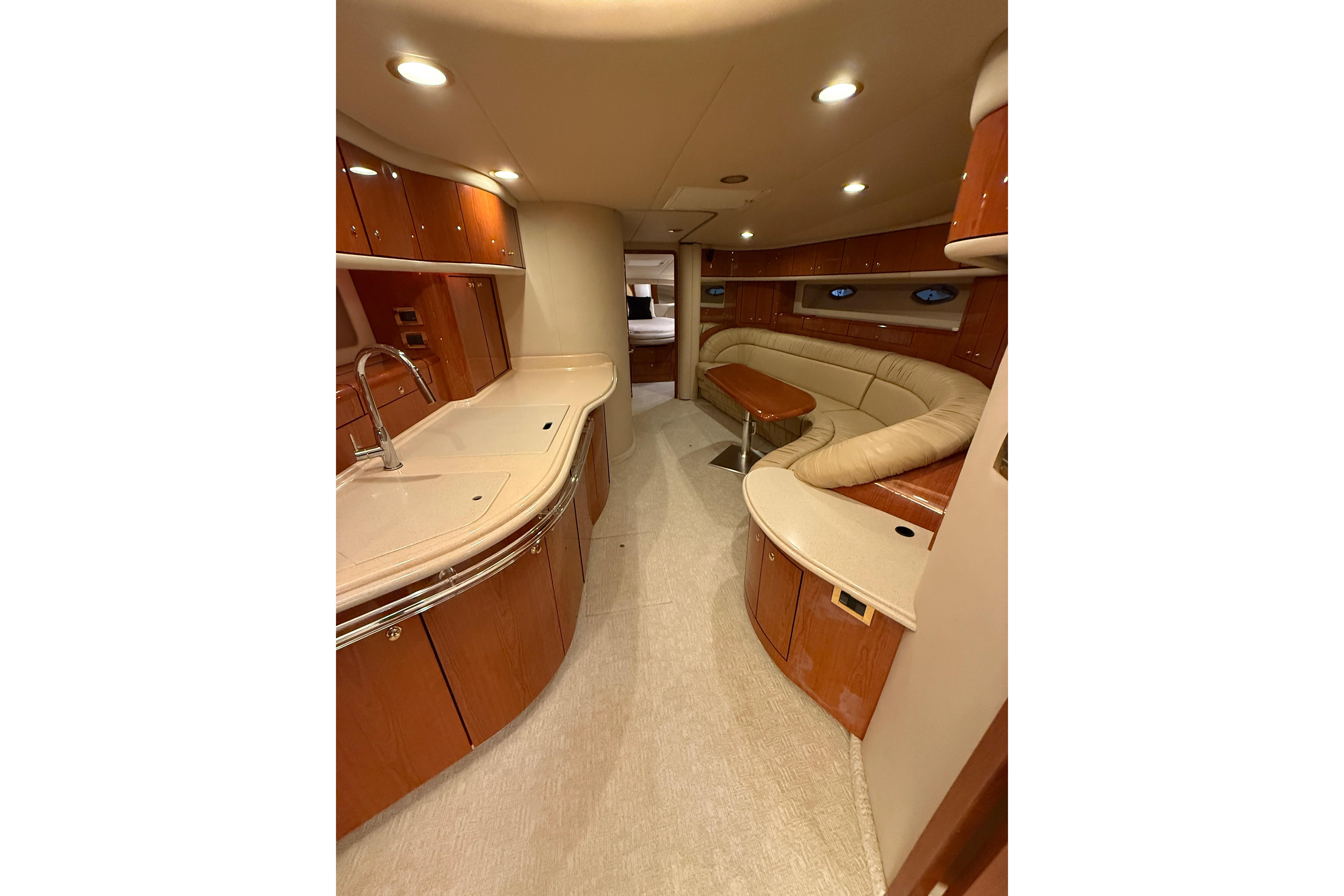 Luxurious interior of 2000 Sea Ray Sundancer 540 yacht with elegant wood finishes.