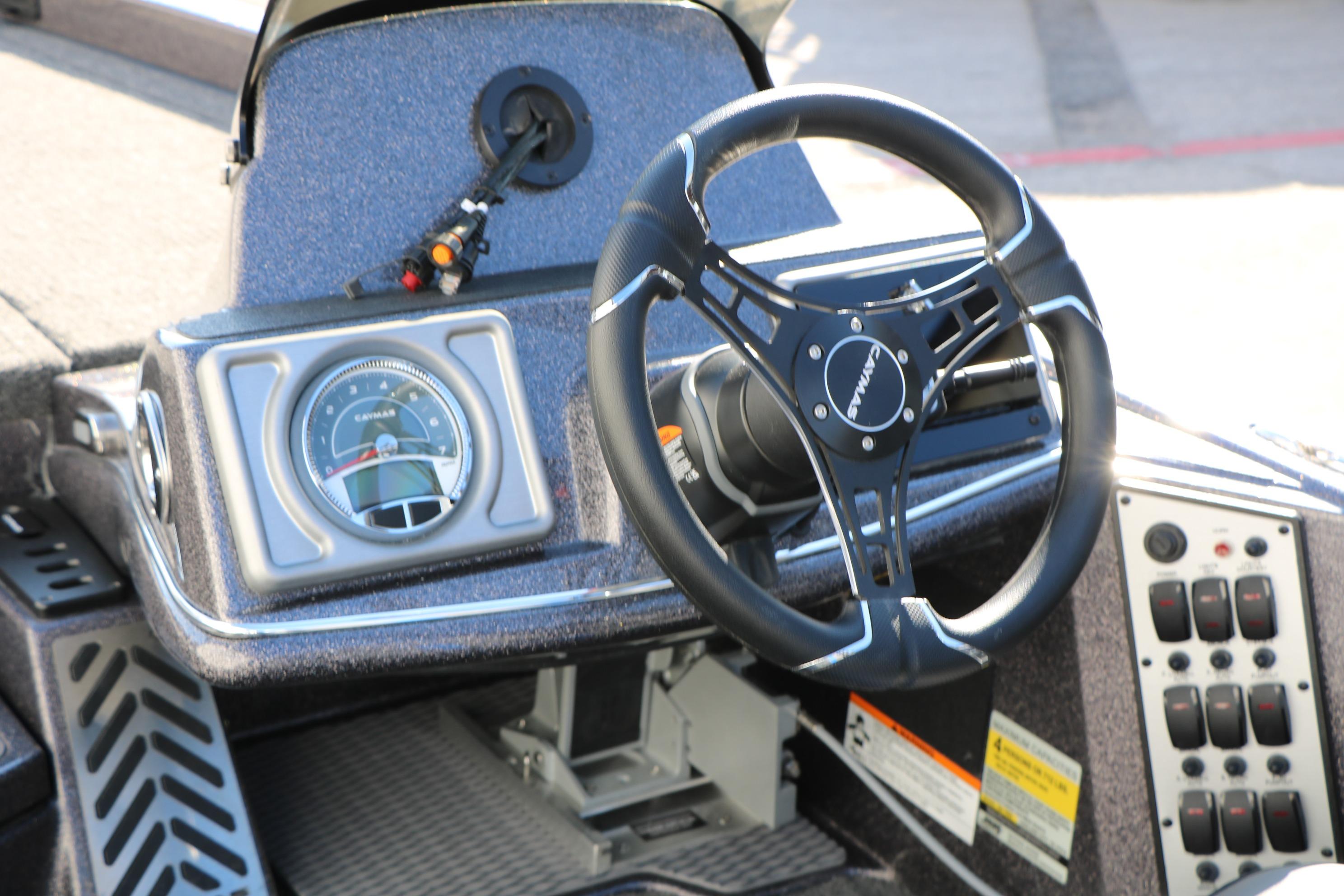 2027 Caymas 201 Pro boat dashboard with steering wheel and control panel.