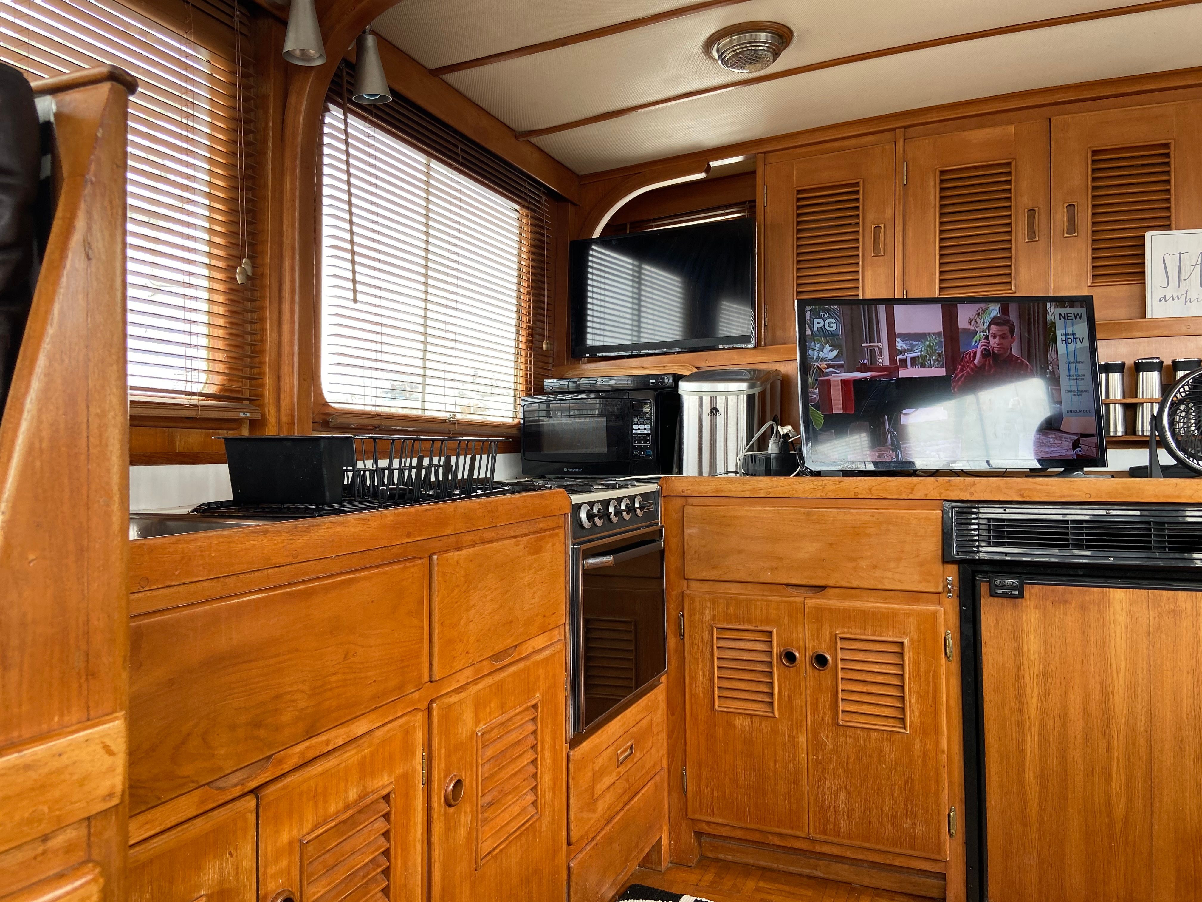 Interior of a 1978 Marine Trader Trawler kitchen with wood paneling.