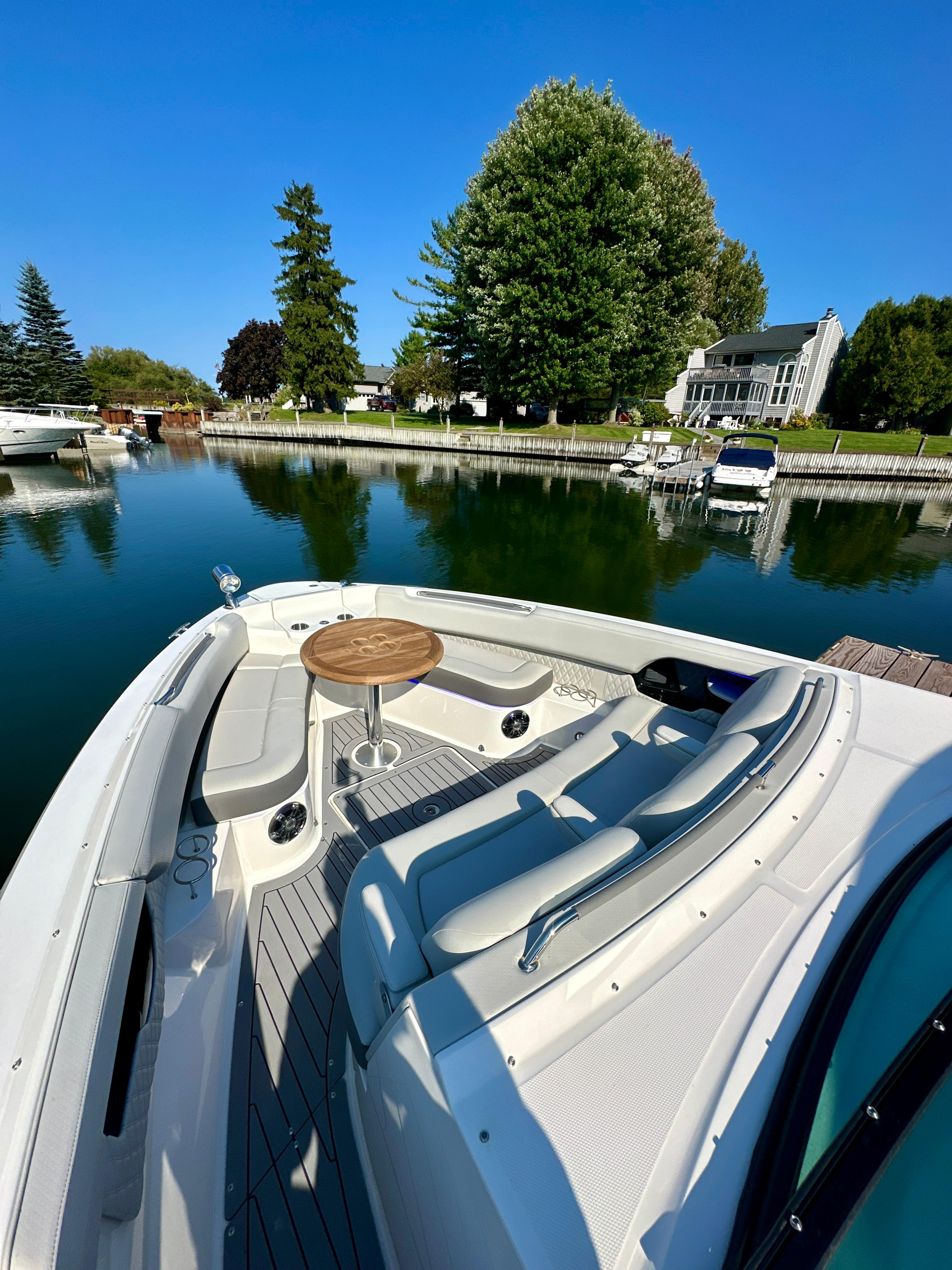 2021 Sea Ray SLX 400 Outboard docked by a serene waterfront property.