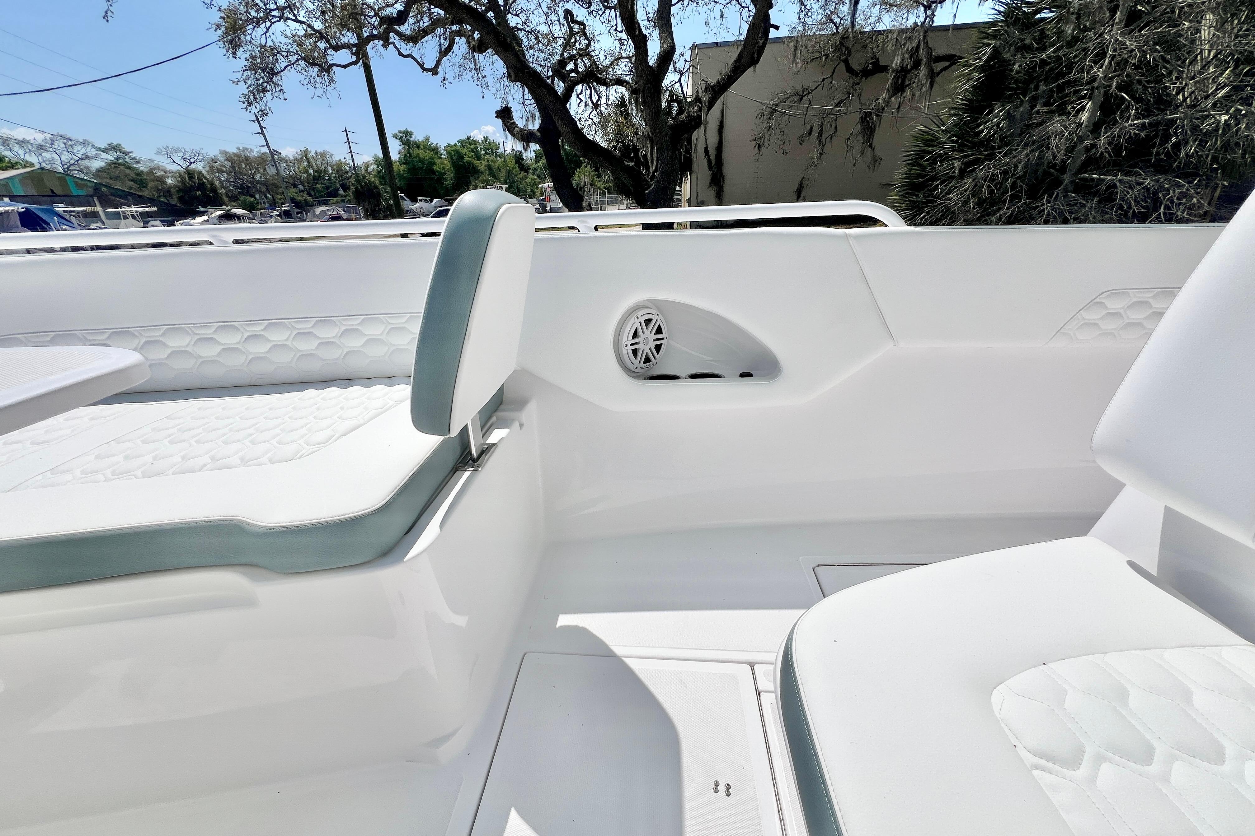 2026 Stamas 31T Aventura boat interior with white seating and speaker detail.