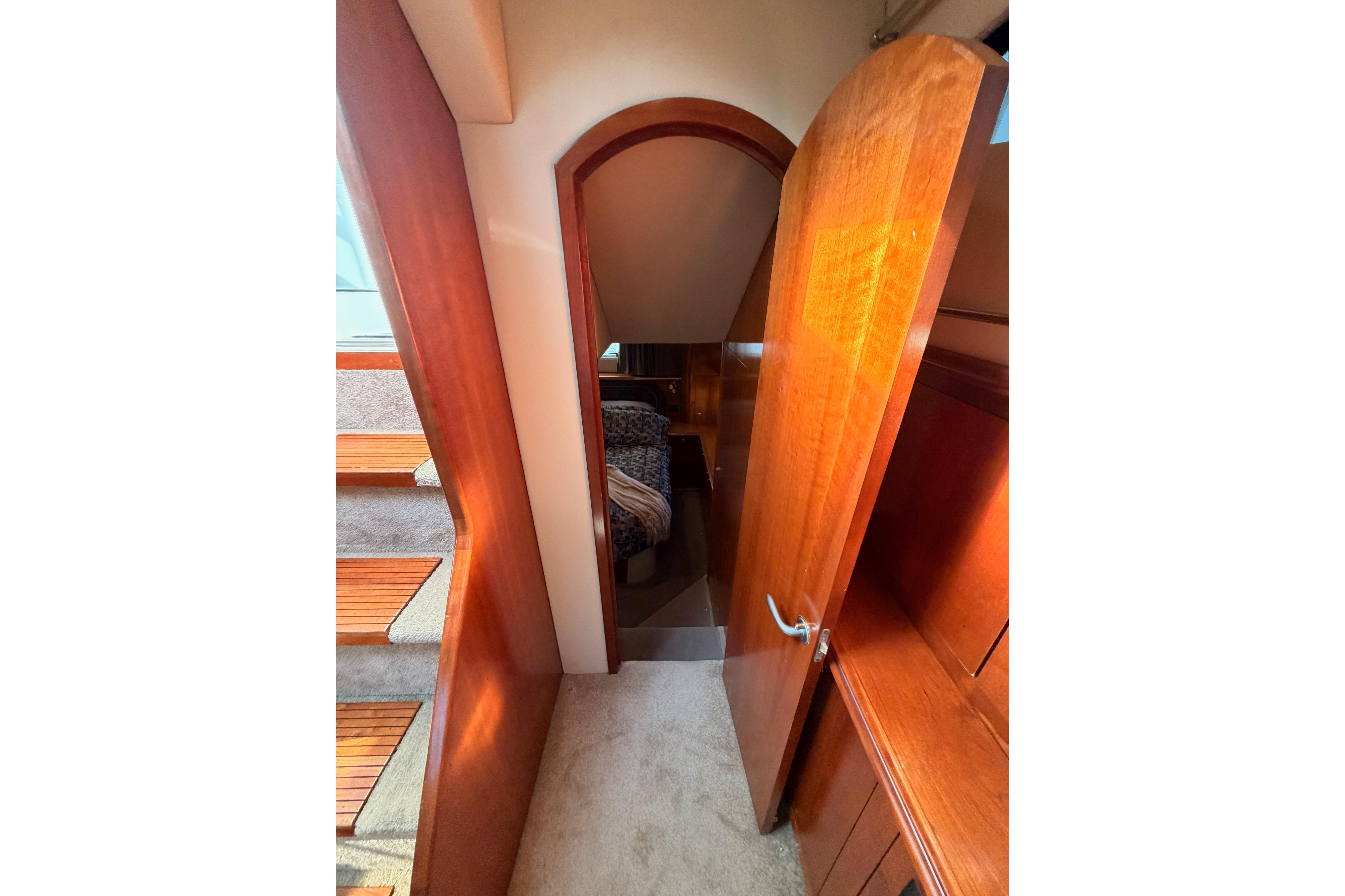 Interior view of 2005 Cruisers Yachts 405 Express Motoryacht with wooden finishes and carpeted stairs.