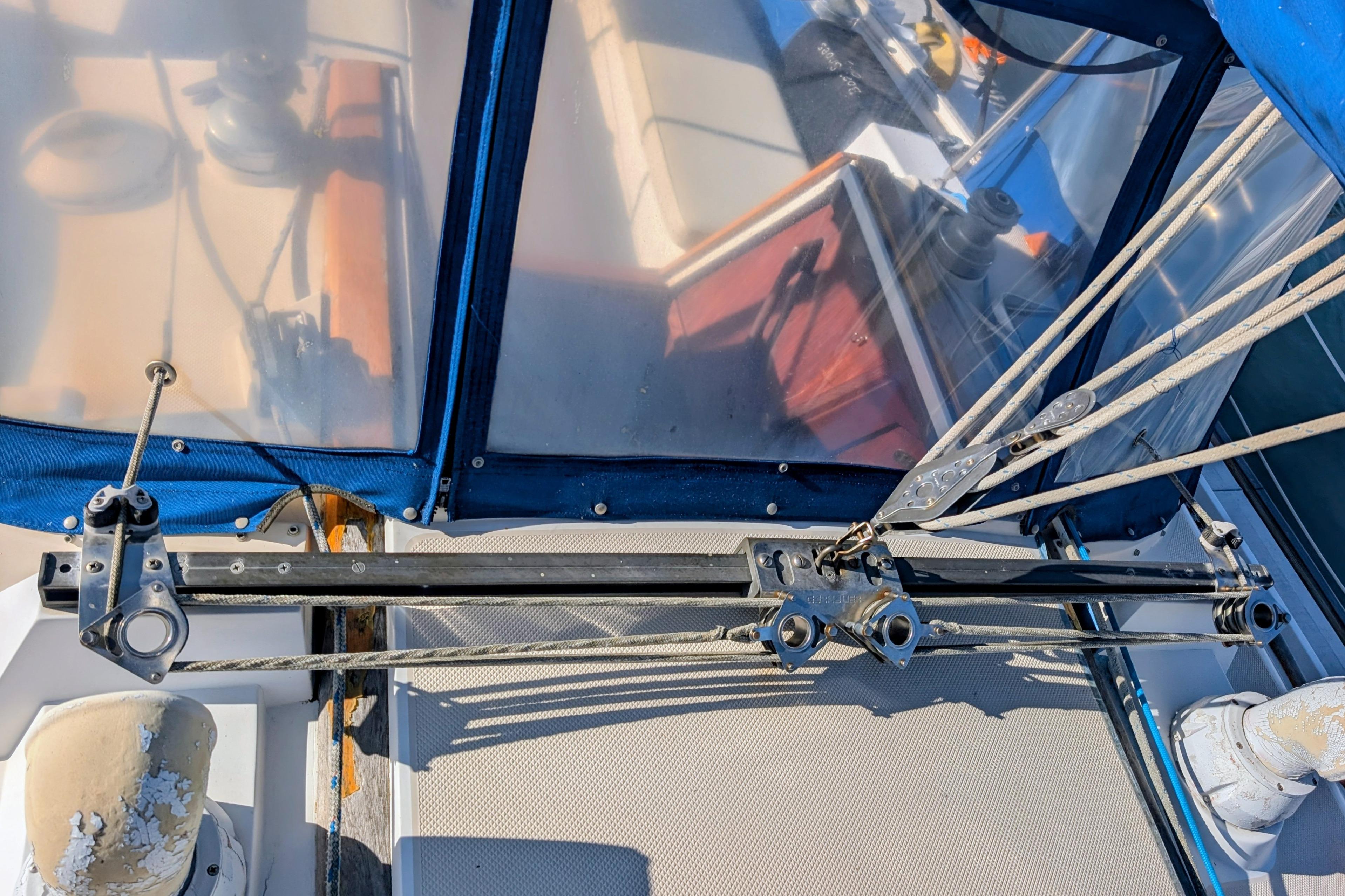 Cockpit view of a 1989 Catalina 34 sailboat with rigging and blue canopy.