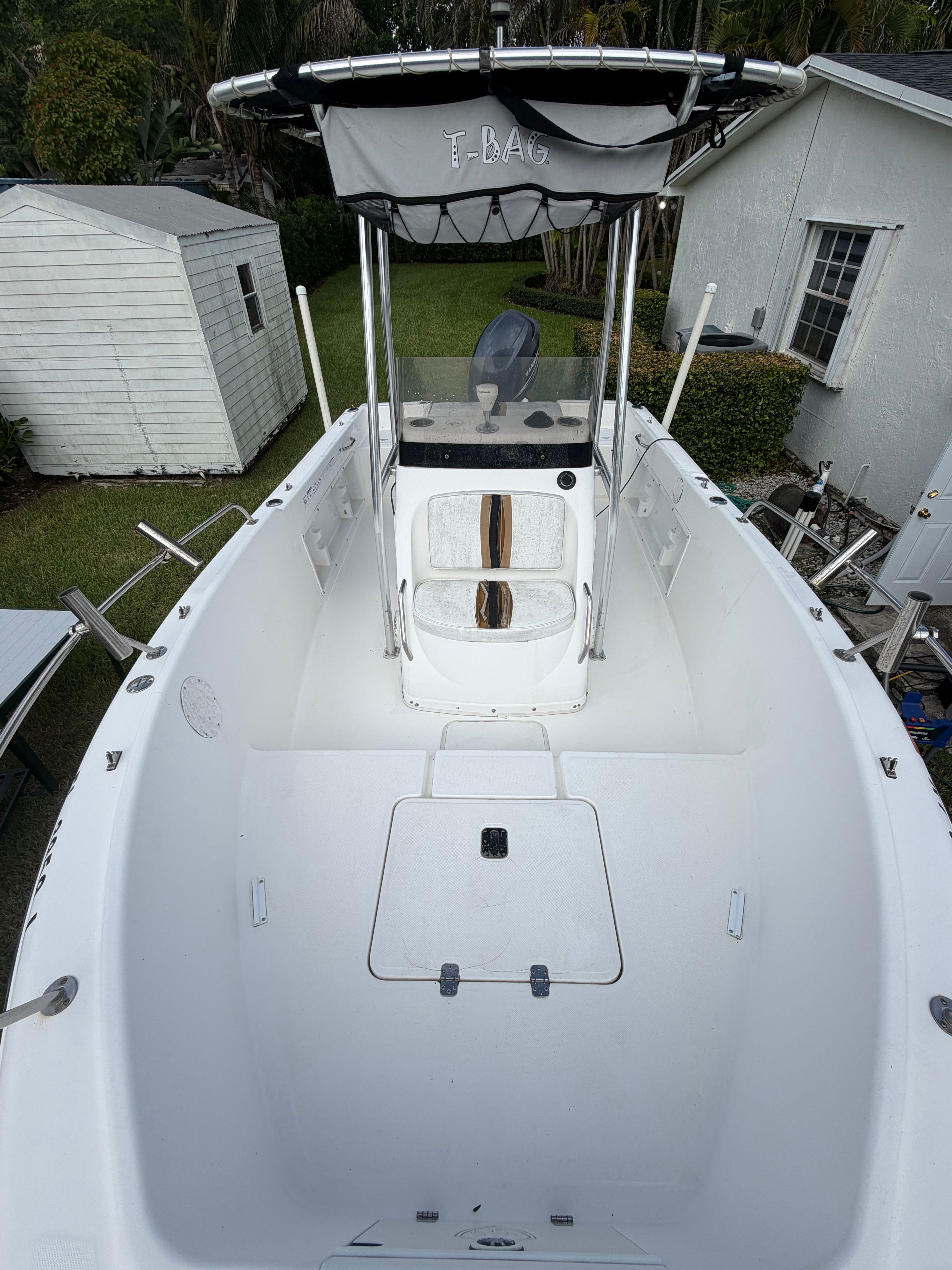 A 2001 Century 2100 Center Console boat with a clean, white deck and T-top.
