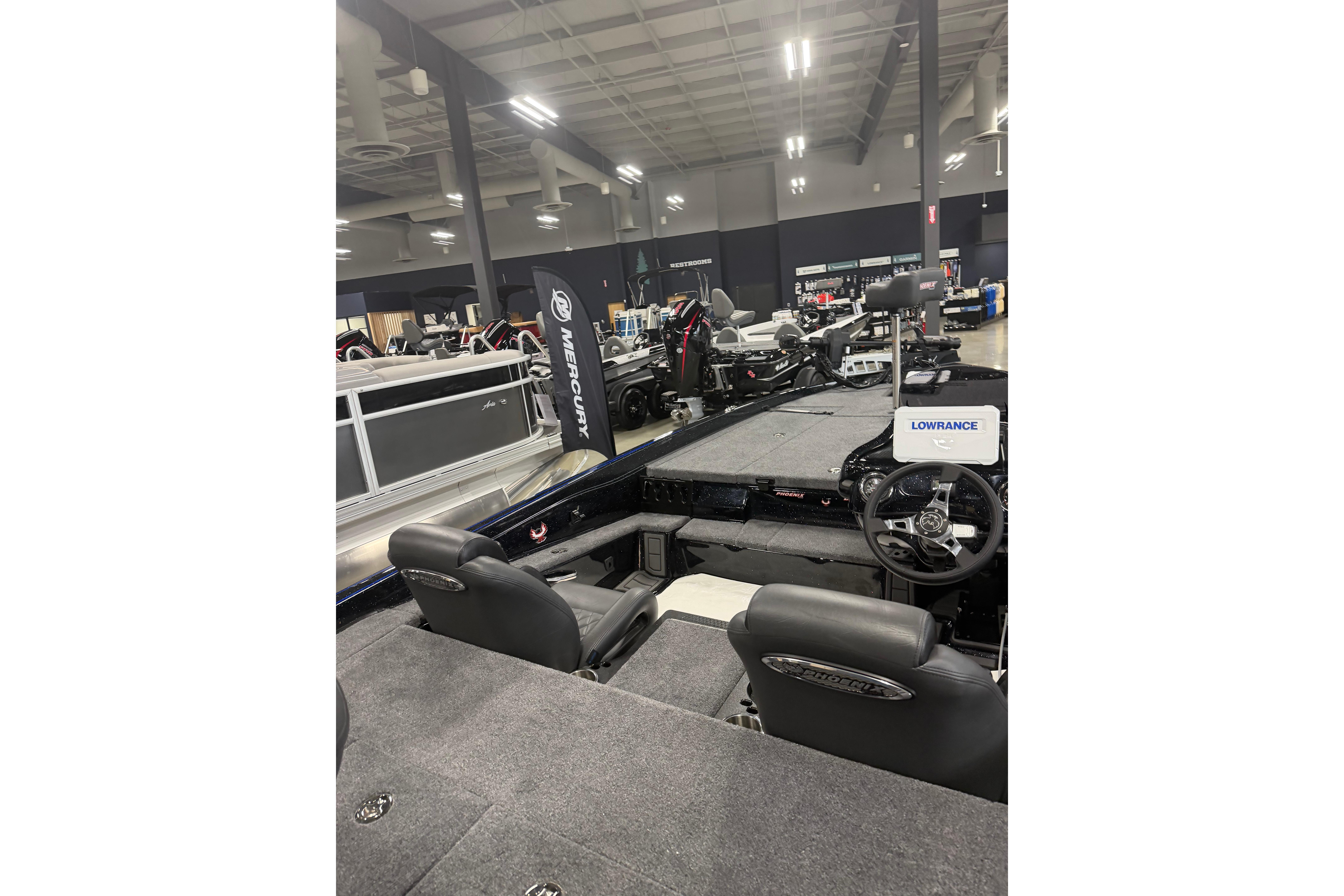 2027 Phoenix 721 ZXL boat interior with Lowrance electronics at a showroom display.