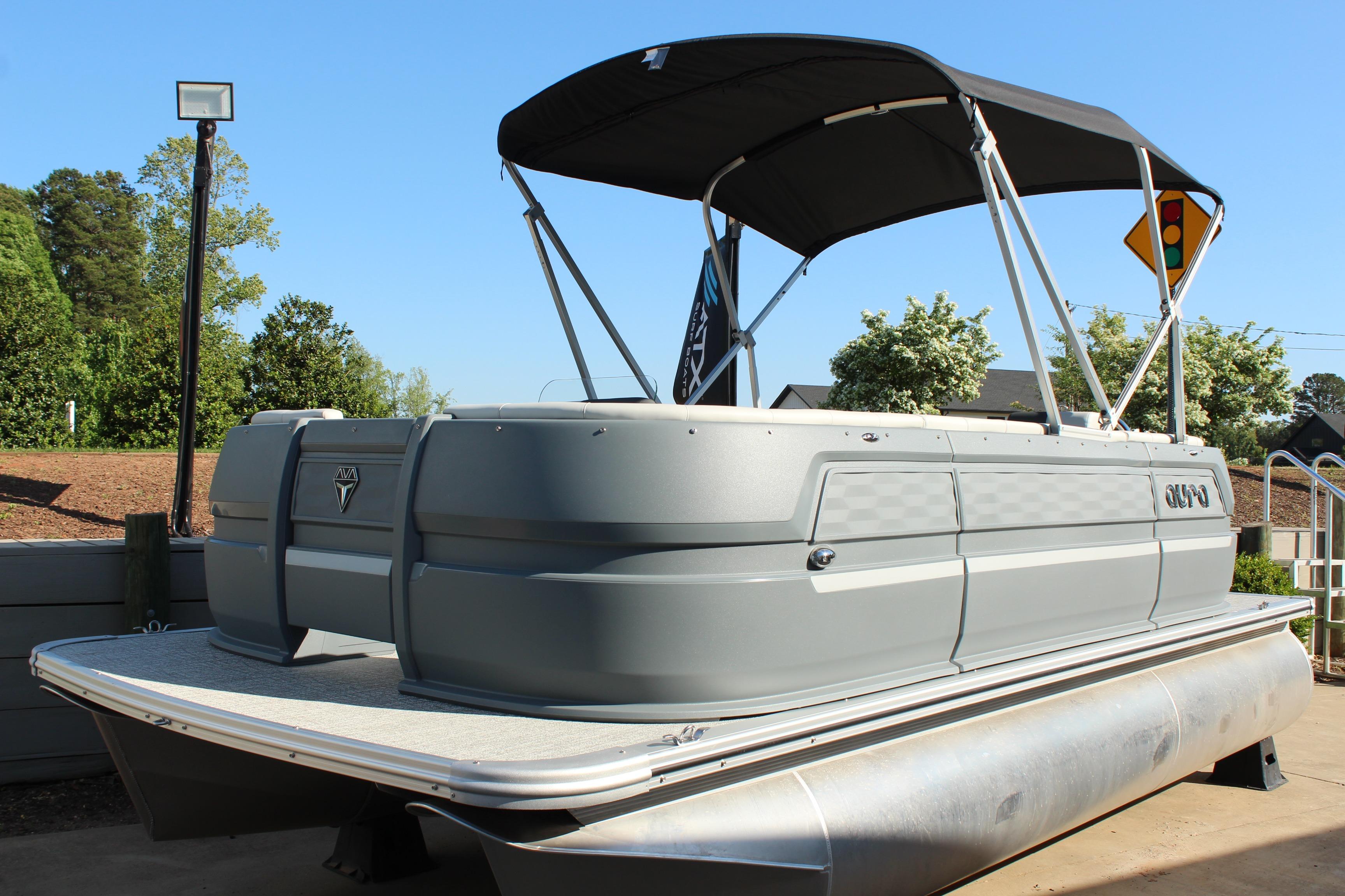 2026 Tahoe Pontoon Aura boat with canopy, docked outdoors on a sunny day.