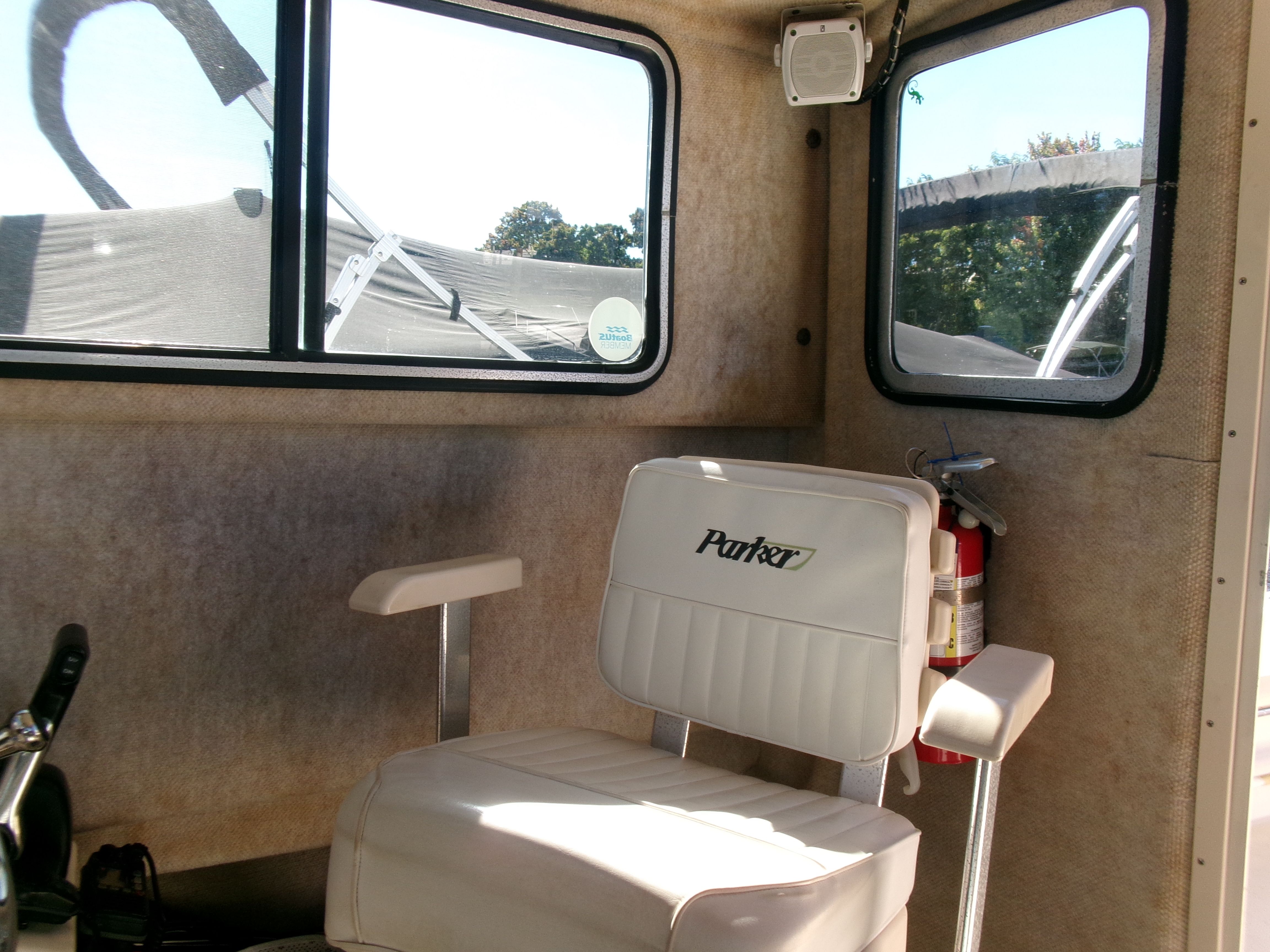 Interior of the 2007 Parker 2520 XL Sport Cabin with white seat and fire extinguisher.