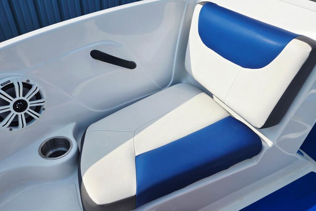 Blue and white seat in 2018 Tahoe 450 TS boat with speaker and cup holder.