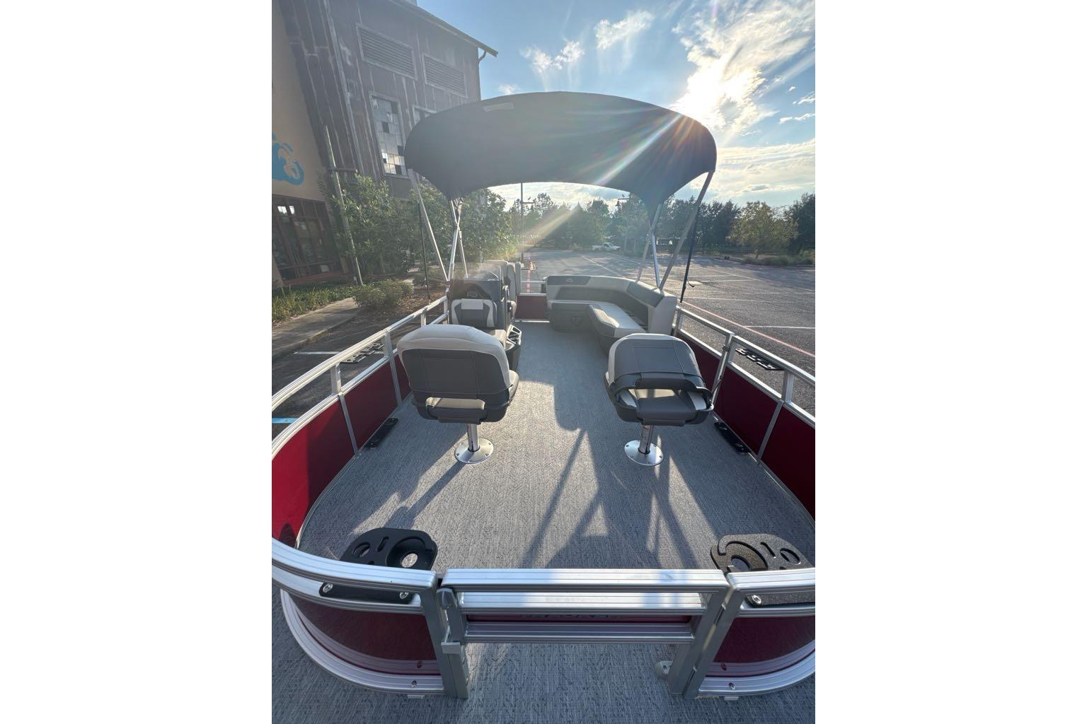2026 Sun Tracker Bass Buggy 16 XL Select pontoon boat with canopy and seating.