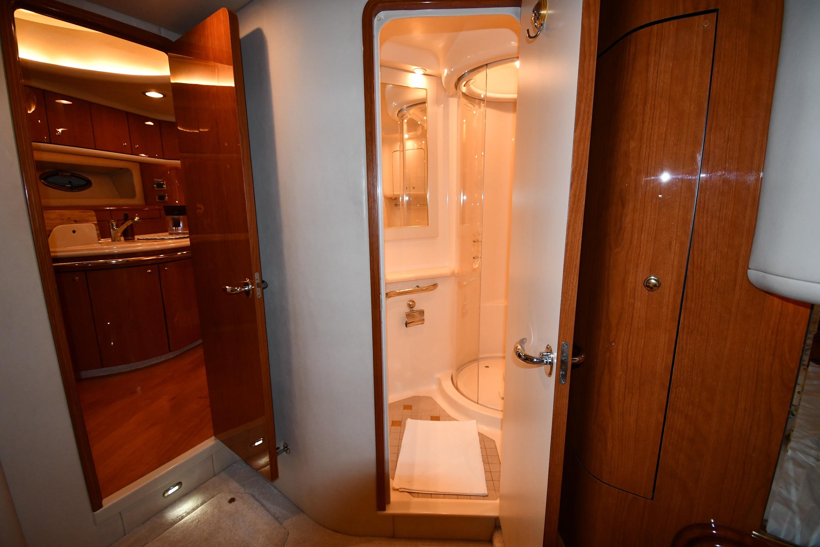 Luxurious bathroom interior of 2001 Sea Ray 540 Sundancer yacht, featuring wood accents and modern amenities.