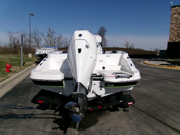 2024 Tahoe 2150 CC boat, rear view, parked on pavement under clear sky.