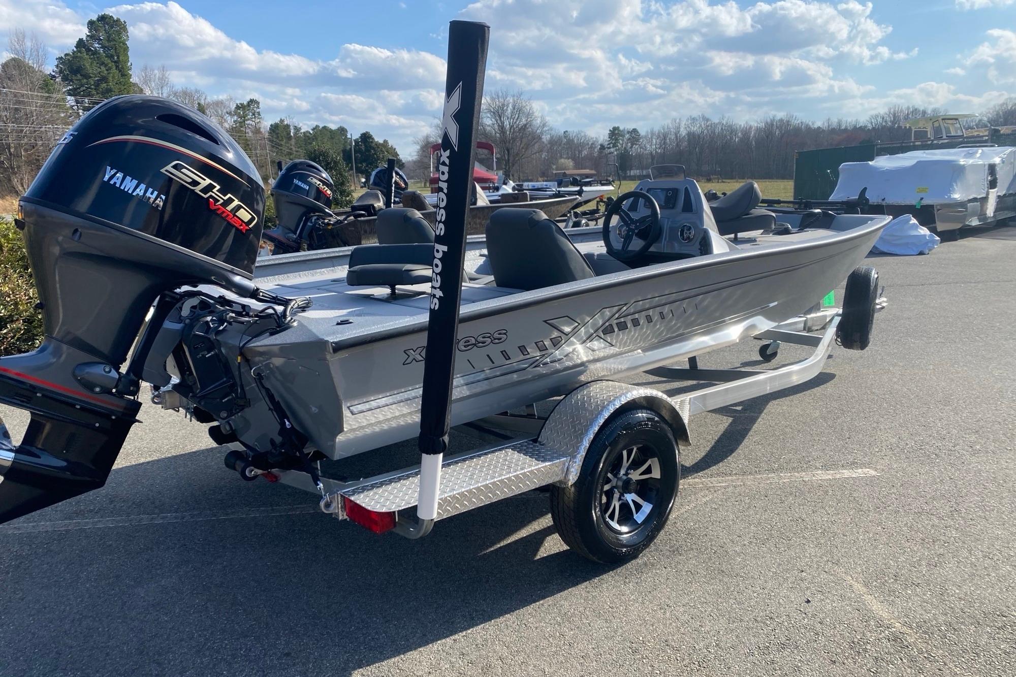 2026 Xpress H18 boat with Yamaha engine on trailer, parked outdoors.