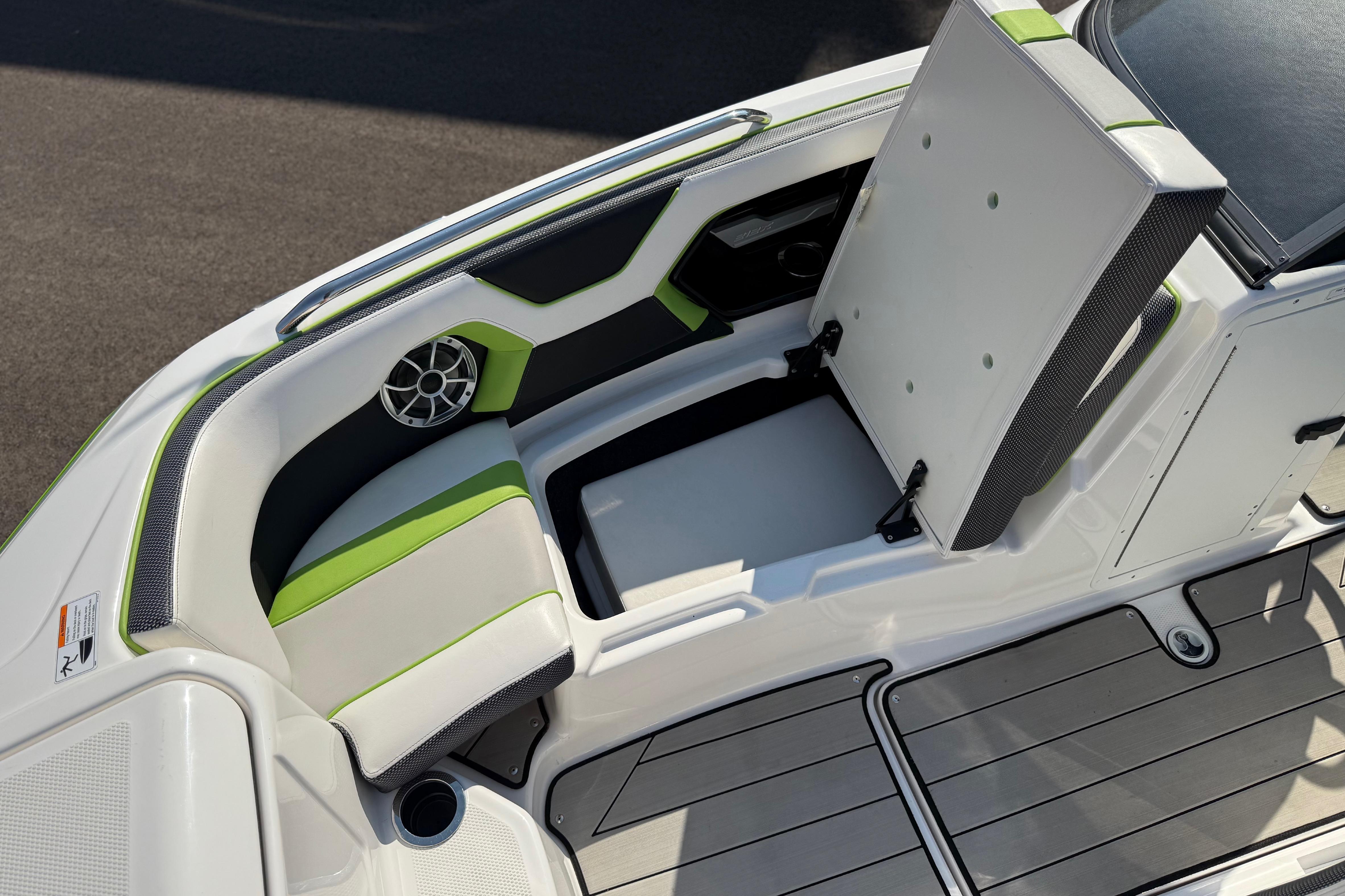 2022 Yamaha Boats 212XE interior with green accents and storage compartment.