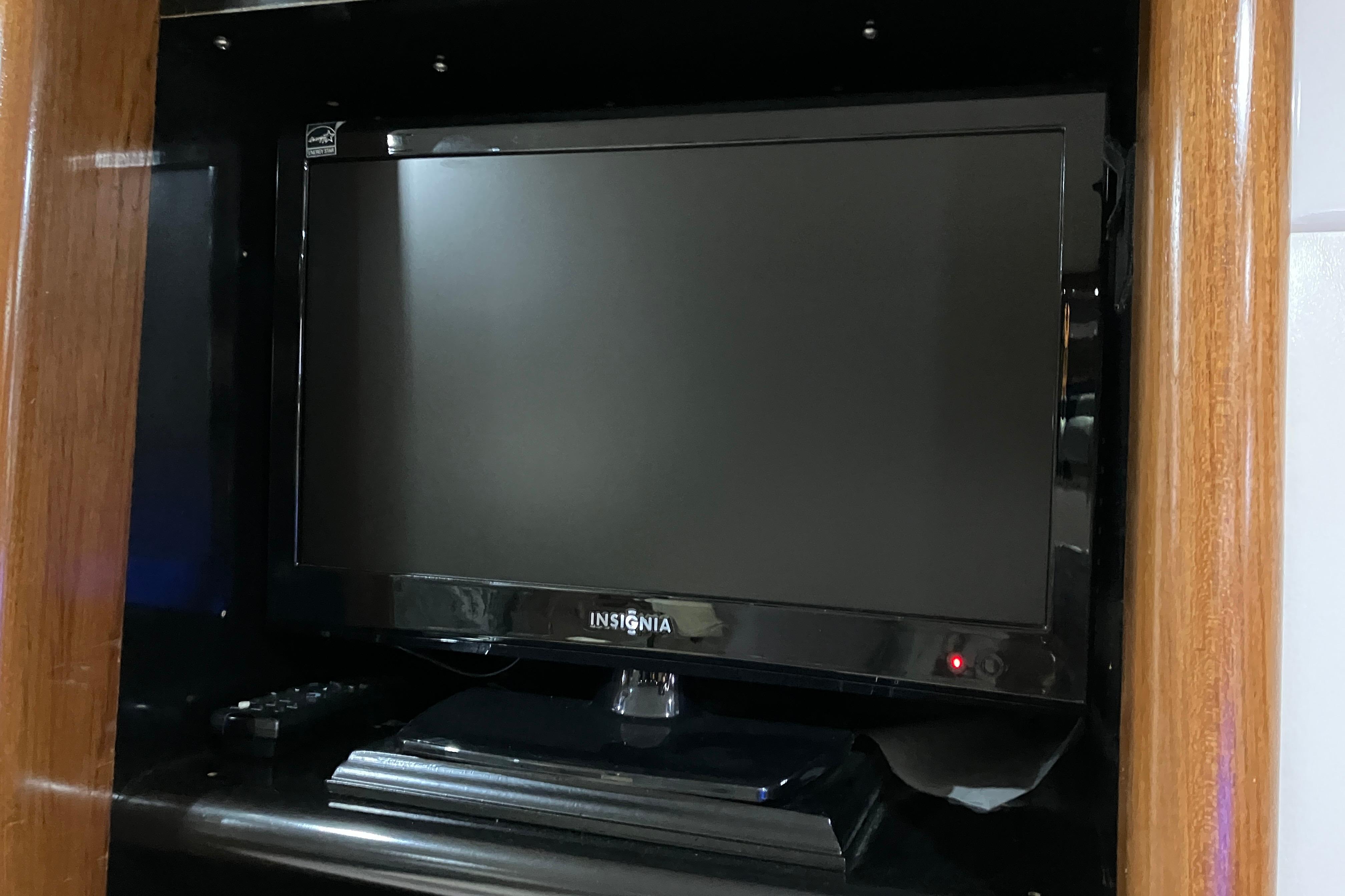 Insignia TV inside 1995 Viking 50 Motor Yacht, wooden cabinet setting.