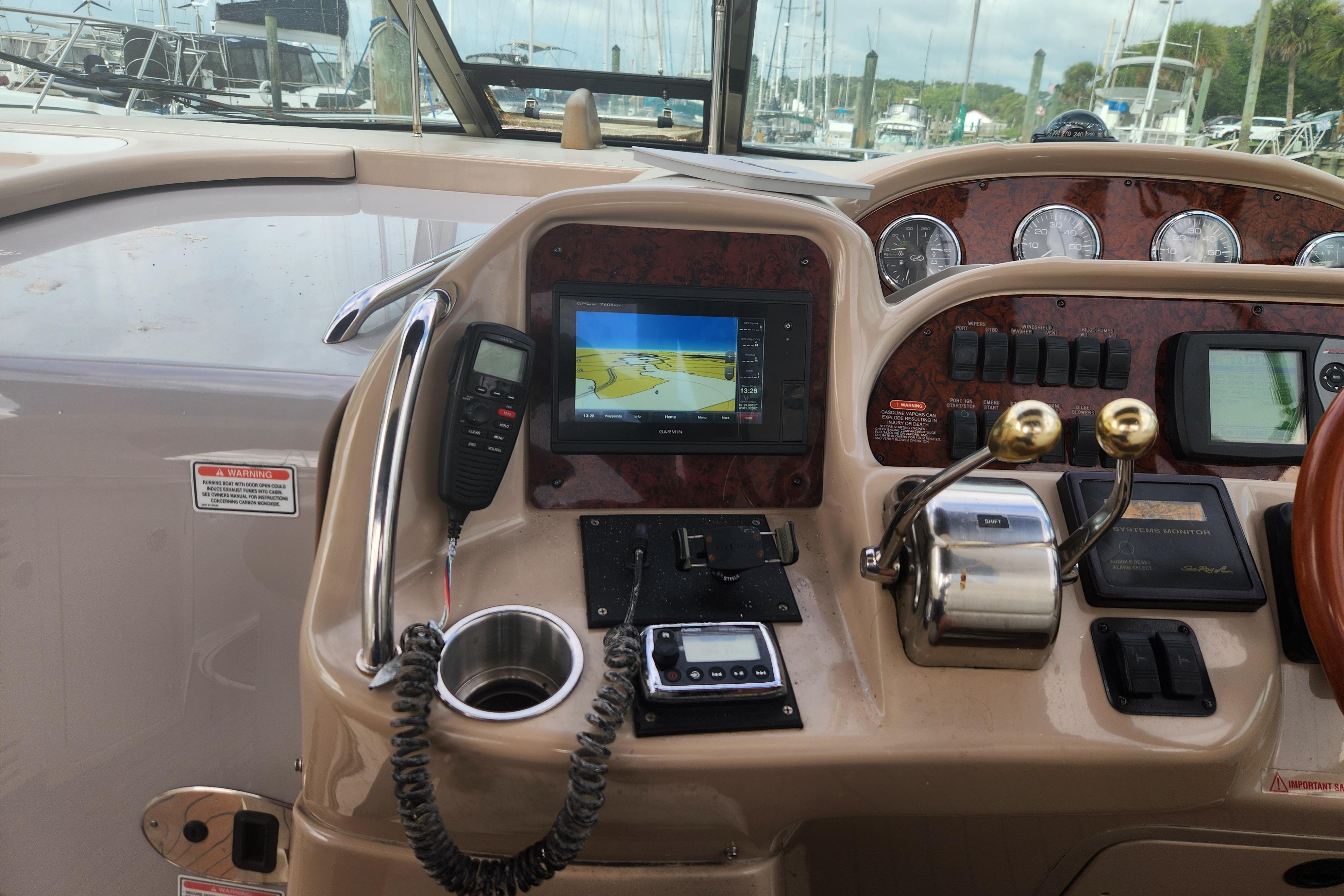 Control panel of a 2003 Sea Ray 360 Sundancer boat with navigation equipment.