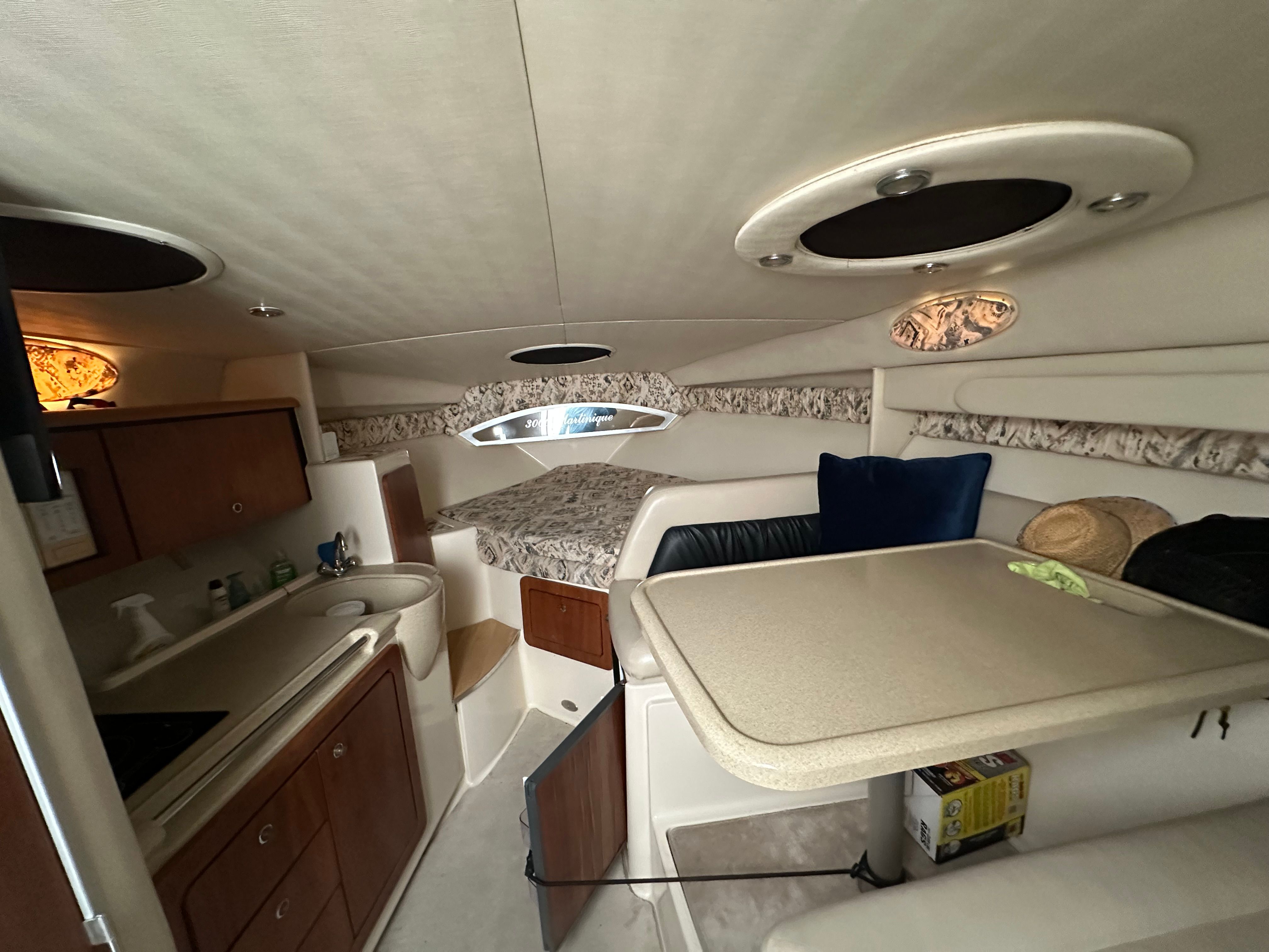 Interior of a 1999 Wellcraft 3000 Matrinique yacht with kitchen and sleeping area.