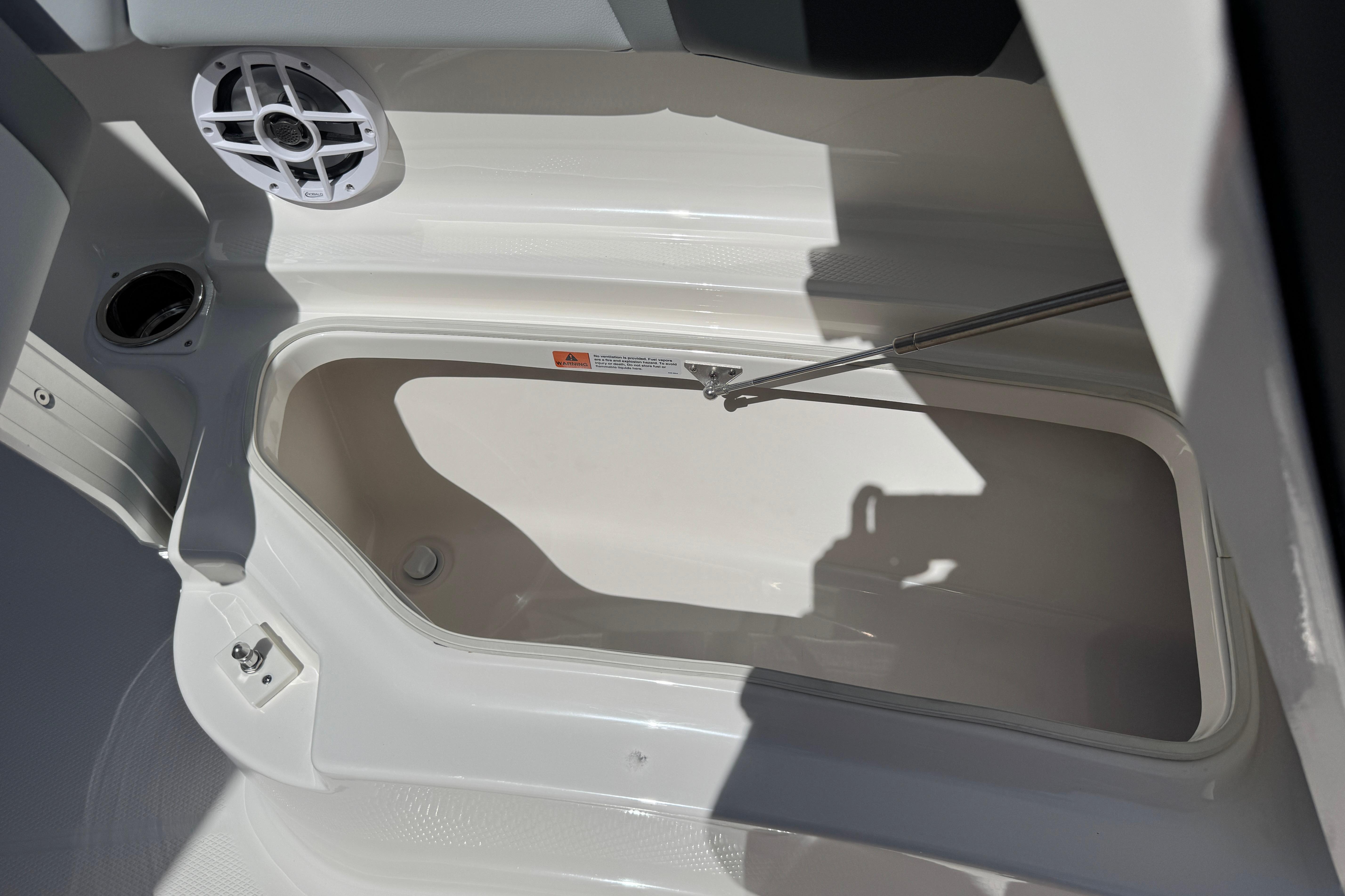 2026 Robalo R250 Center Console boat storage compartment with speaker and latch.