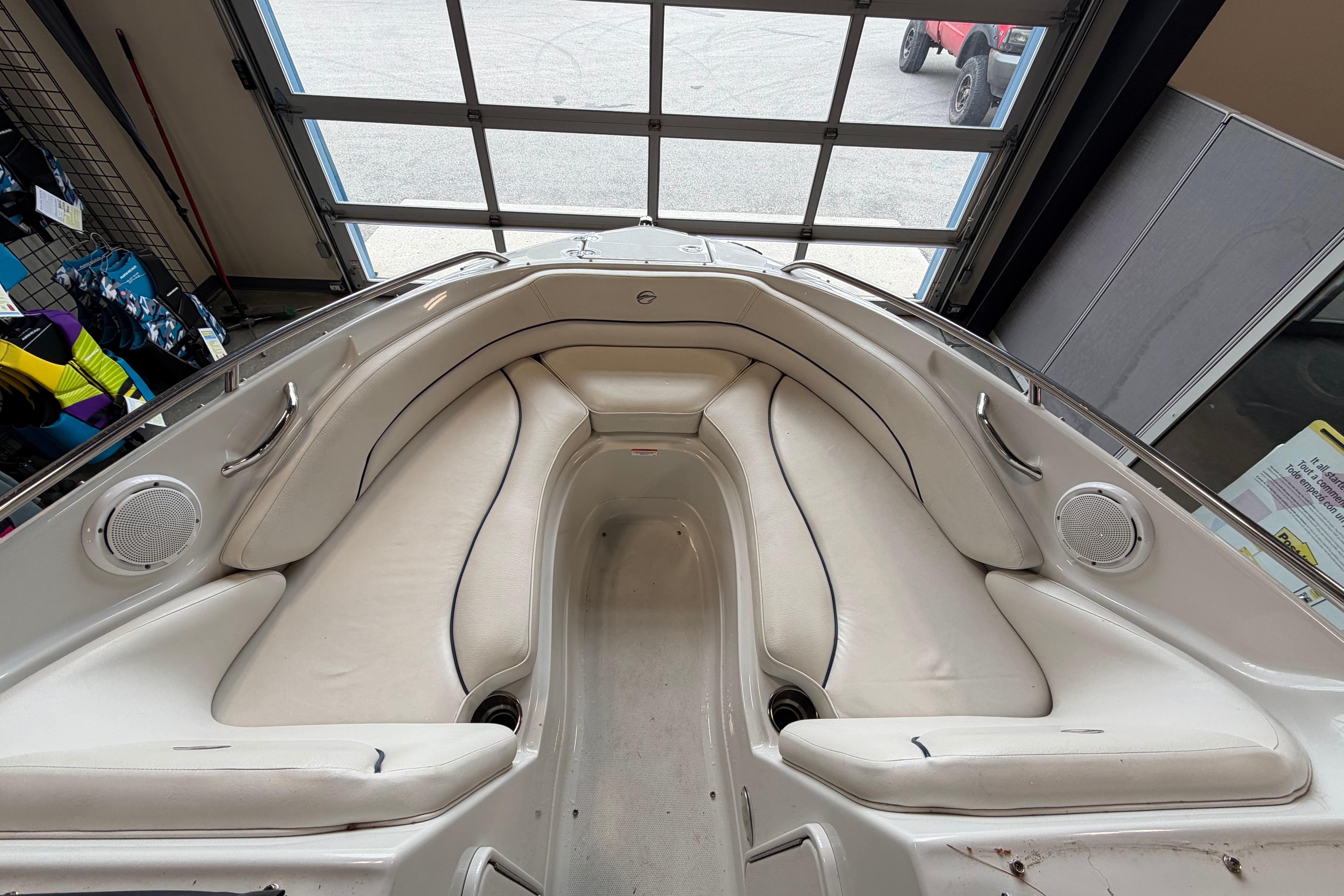 Interior view of a 2008 Crownline 220 LS boat with white seating and speakers.