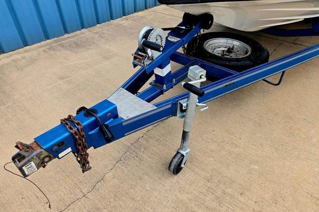 Trailer hitch of a 1996 Champion 181 SX boat, featuring a blue frame and wheel.