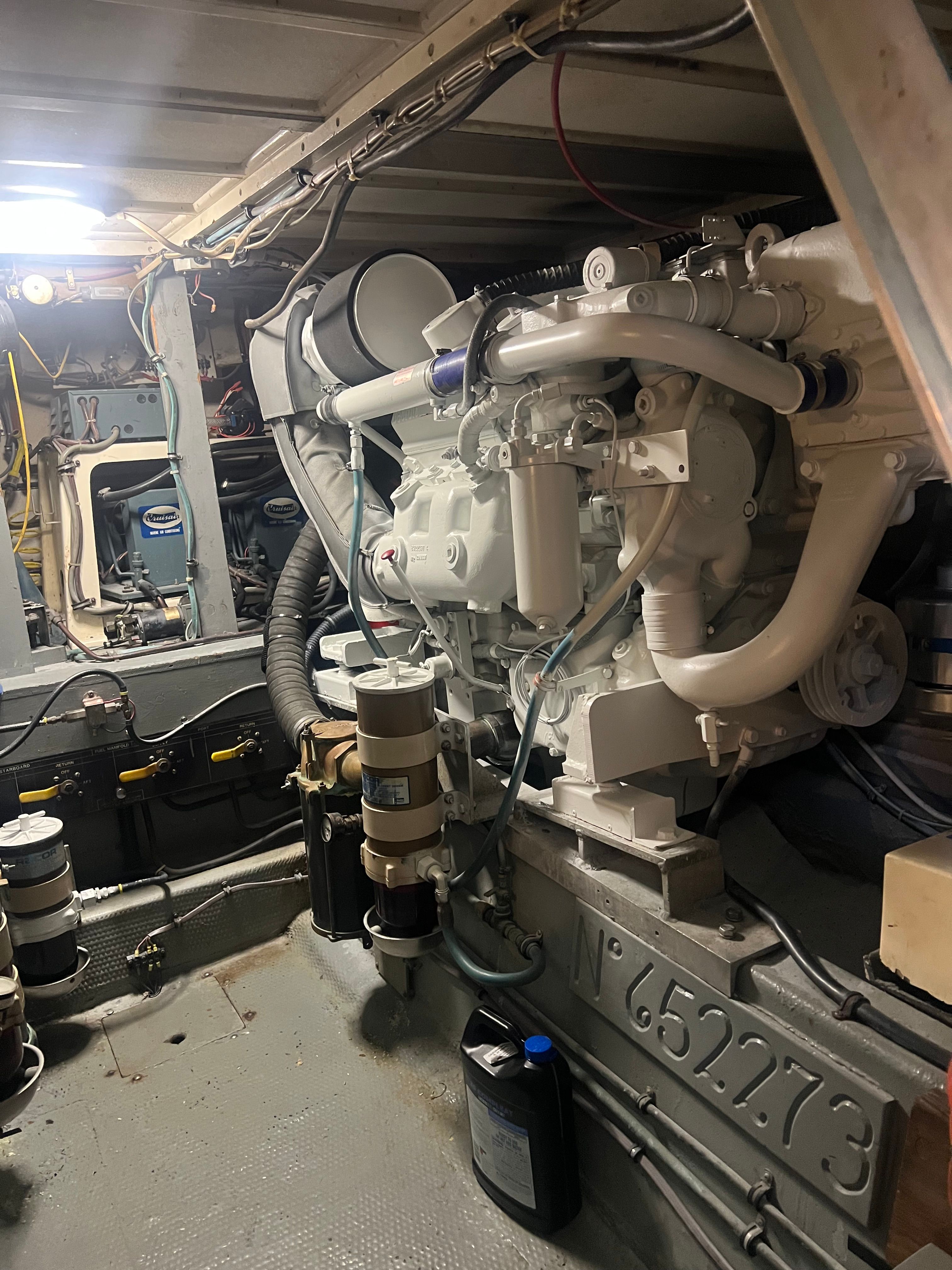 Engine room of a 1981 Hatteras Motoryacht with visible engine.