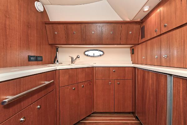 Luxurious wooden interior of 2008 Tiara Yachts 4200 Open, featuring ample cabinetry and sleek design.