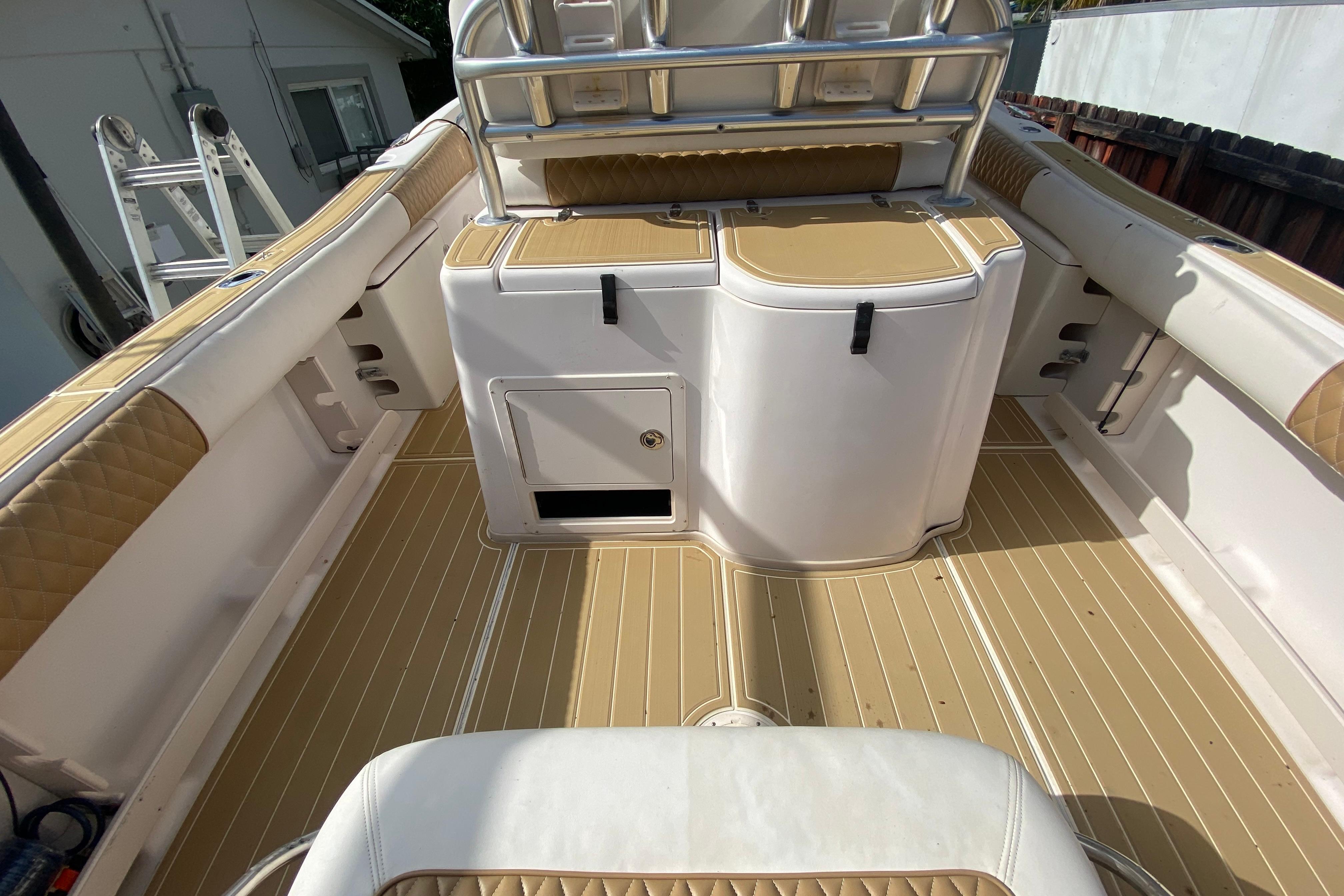 2004 Grady-White Canyon 283 boat interior with tan and white seating and storage compartments.