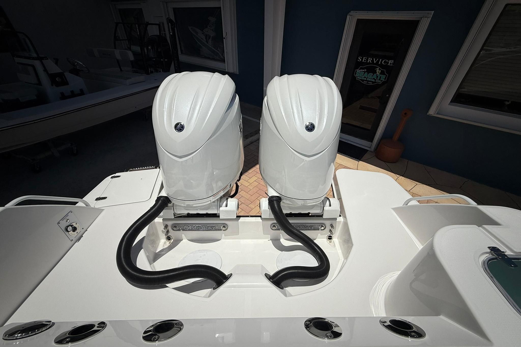Edgewater 250CC 2026 model with dual outboard engines, showcased at a service center.