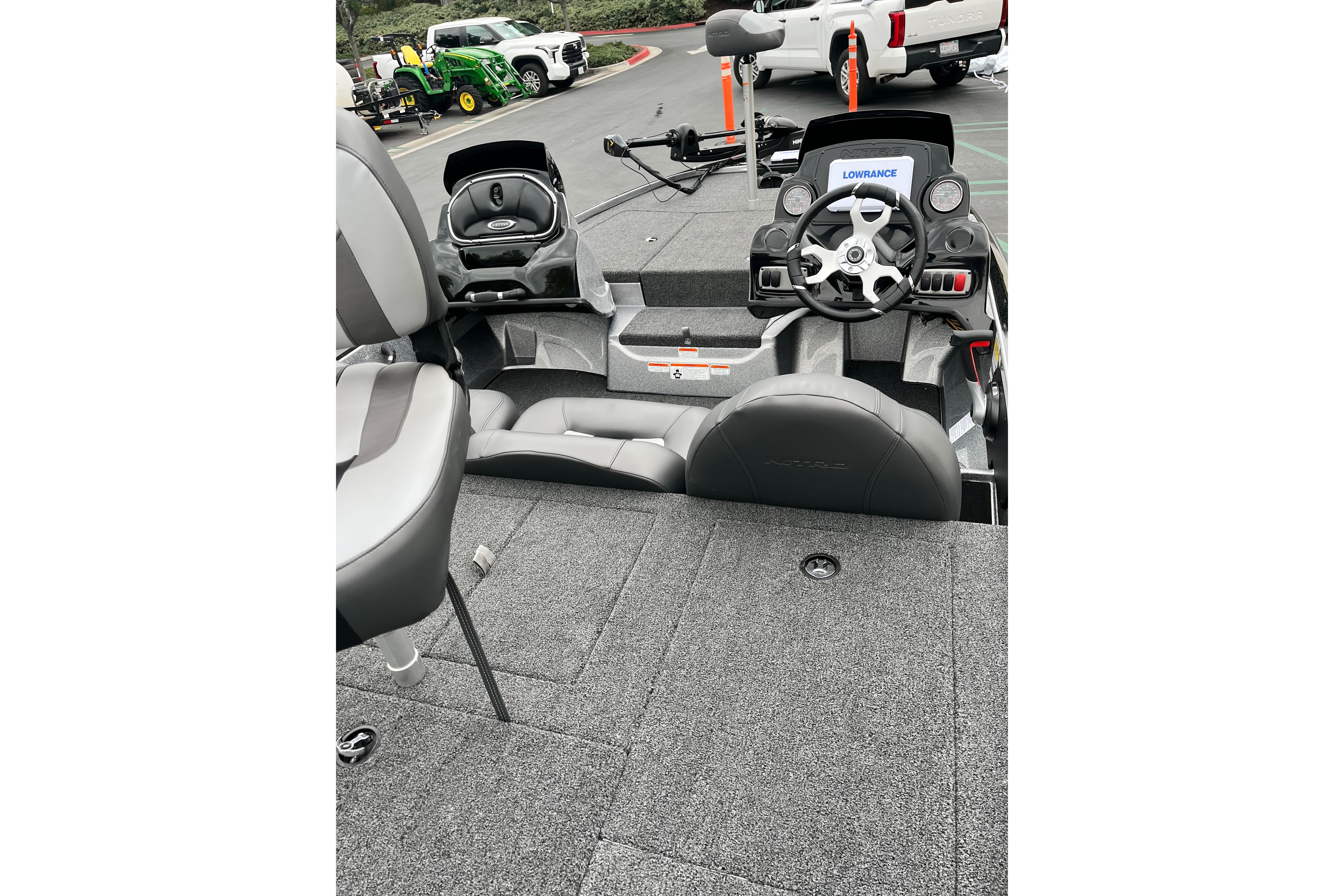 2026 Nitro Z17 boat interior with steering wheel and seating, parked outdoors.