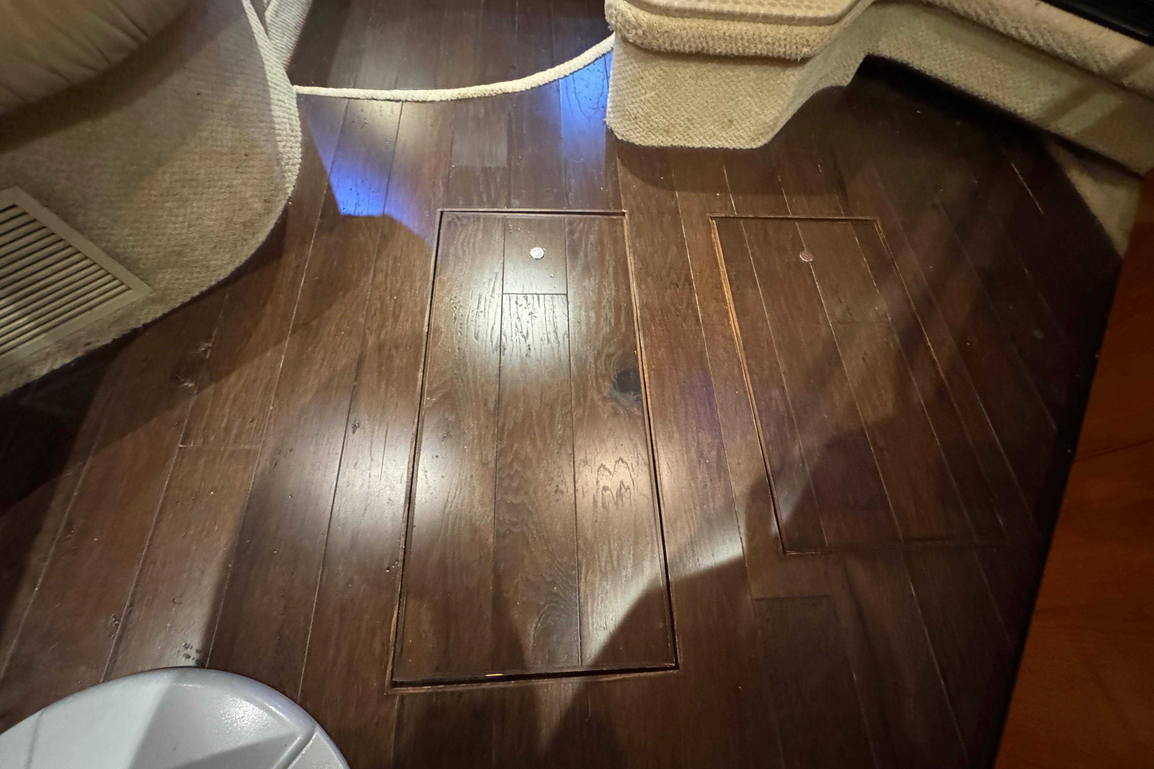 Dark wood flooring on a 2001 Sea Ray 380 Sundancer yacht interior.