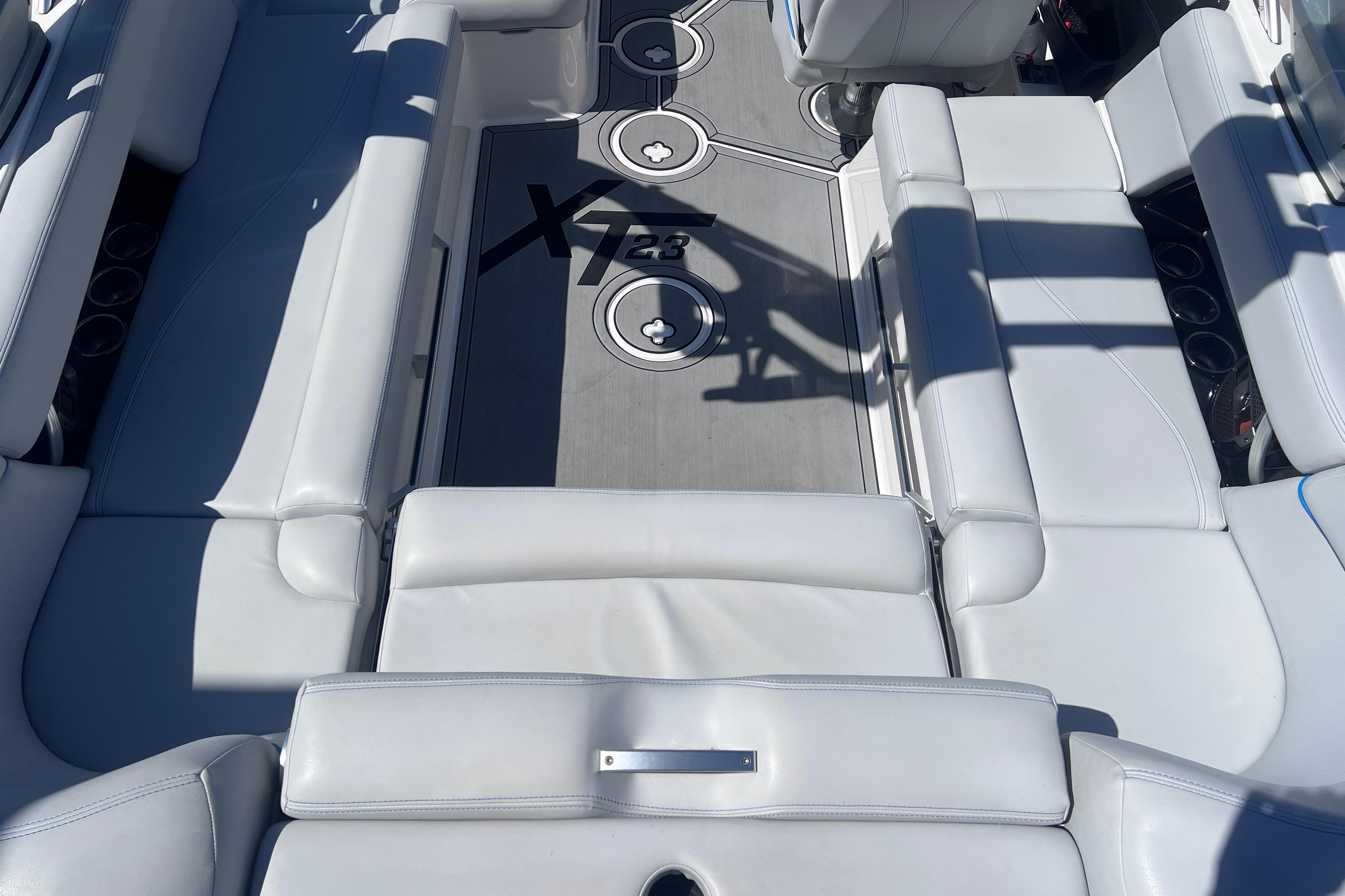 2021 MasterCraft XT23 boat interior with sleek white seating and modern design.