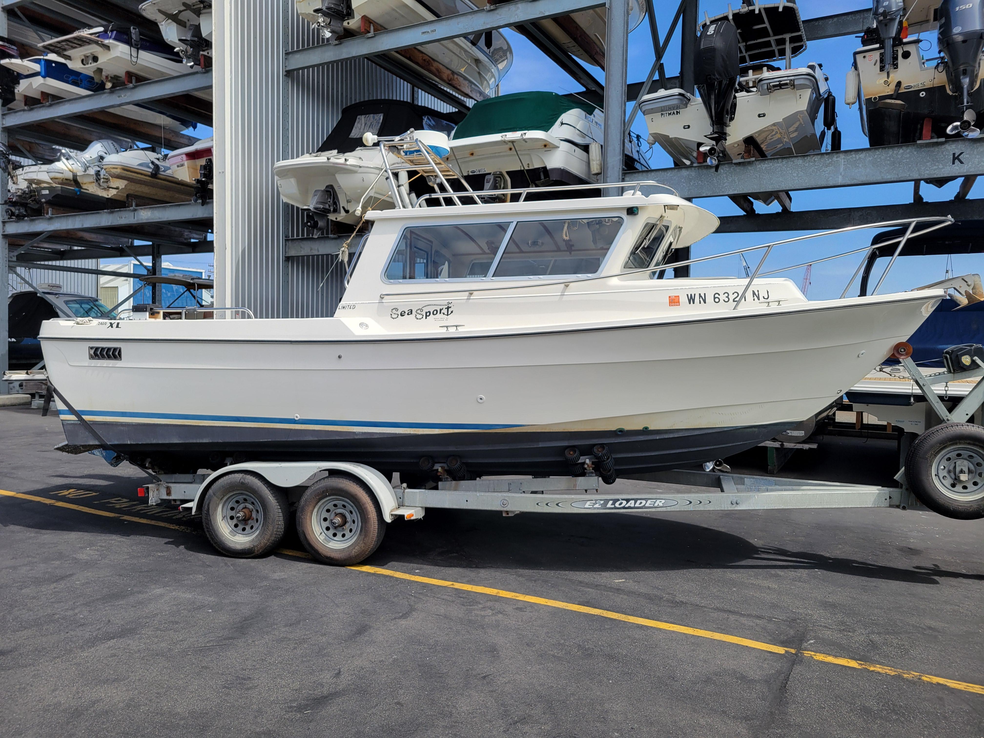1999 SeaSport 2400 XL Limited boat on trailer in marina storage facility.