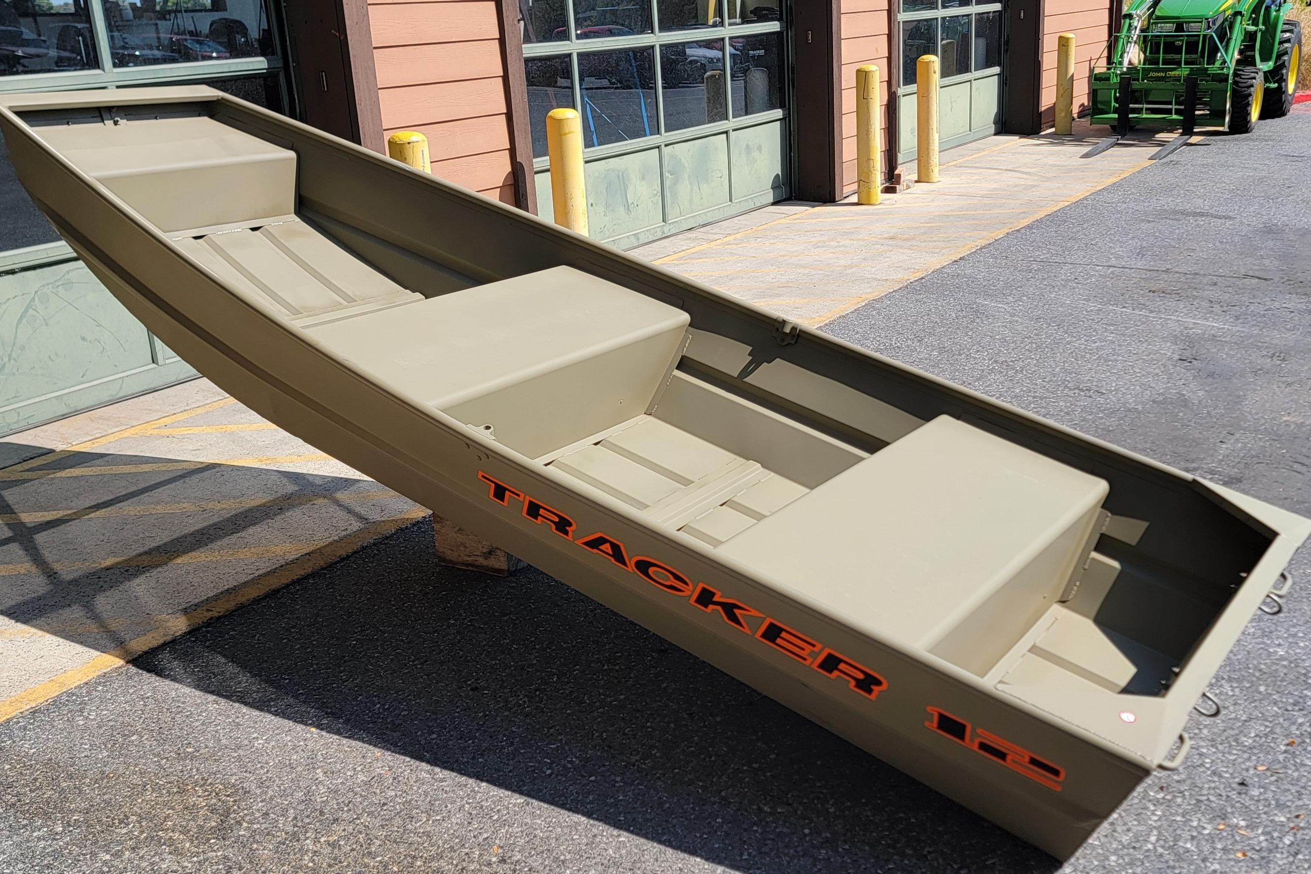 2026 Tracker Grizzly 12 Jon boat displayed outdoors near a building.