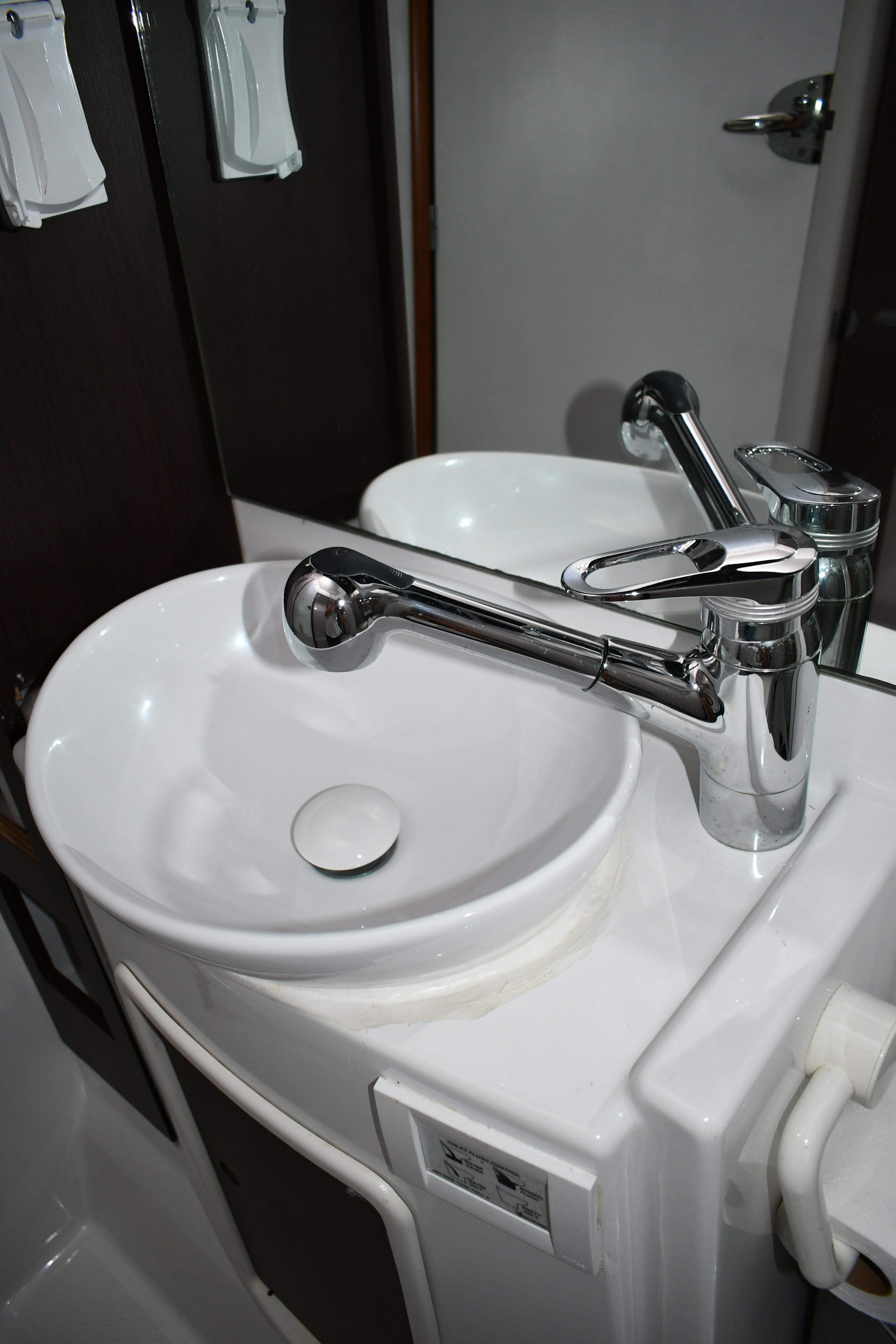 Bathroom sink with modern faucet on 2012 Fountaine Pajot 40 yacht.