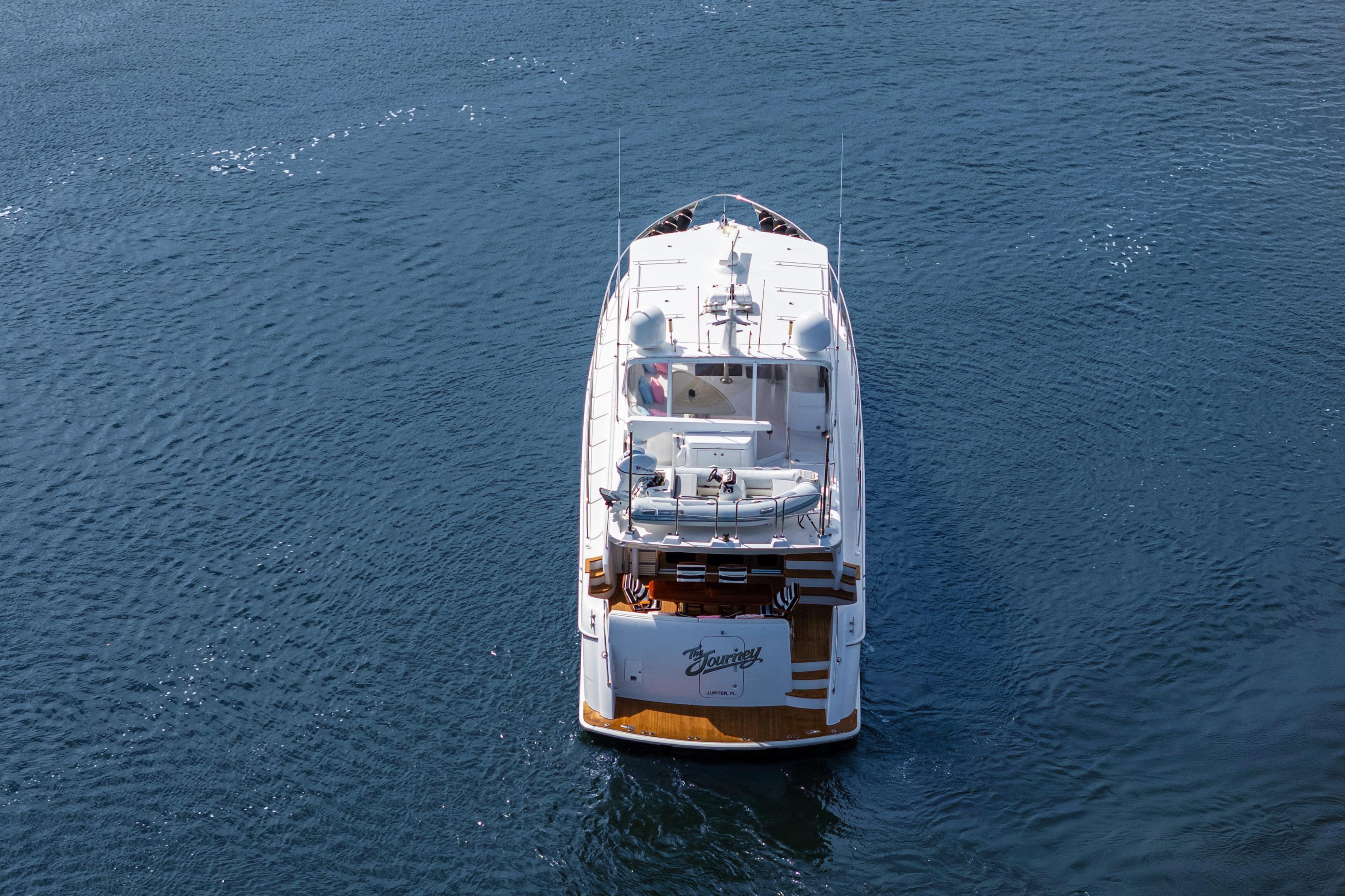 2008 Hatteras 64 Motor Yacht cruising on open water, aerial view.