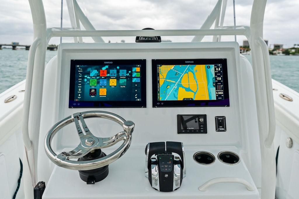 2021 Yellowfin 36 Offshore boat dashboard with dual Simrad displays and steering wheel.